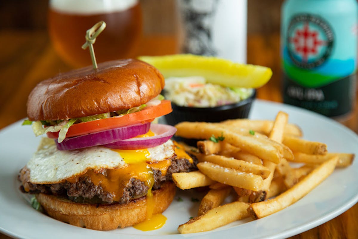 a close up of a sandwich and fries on a plate