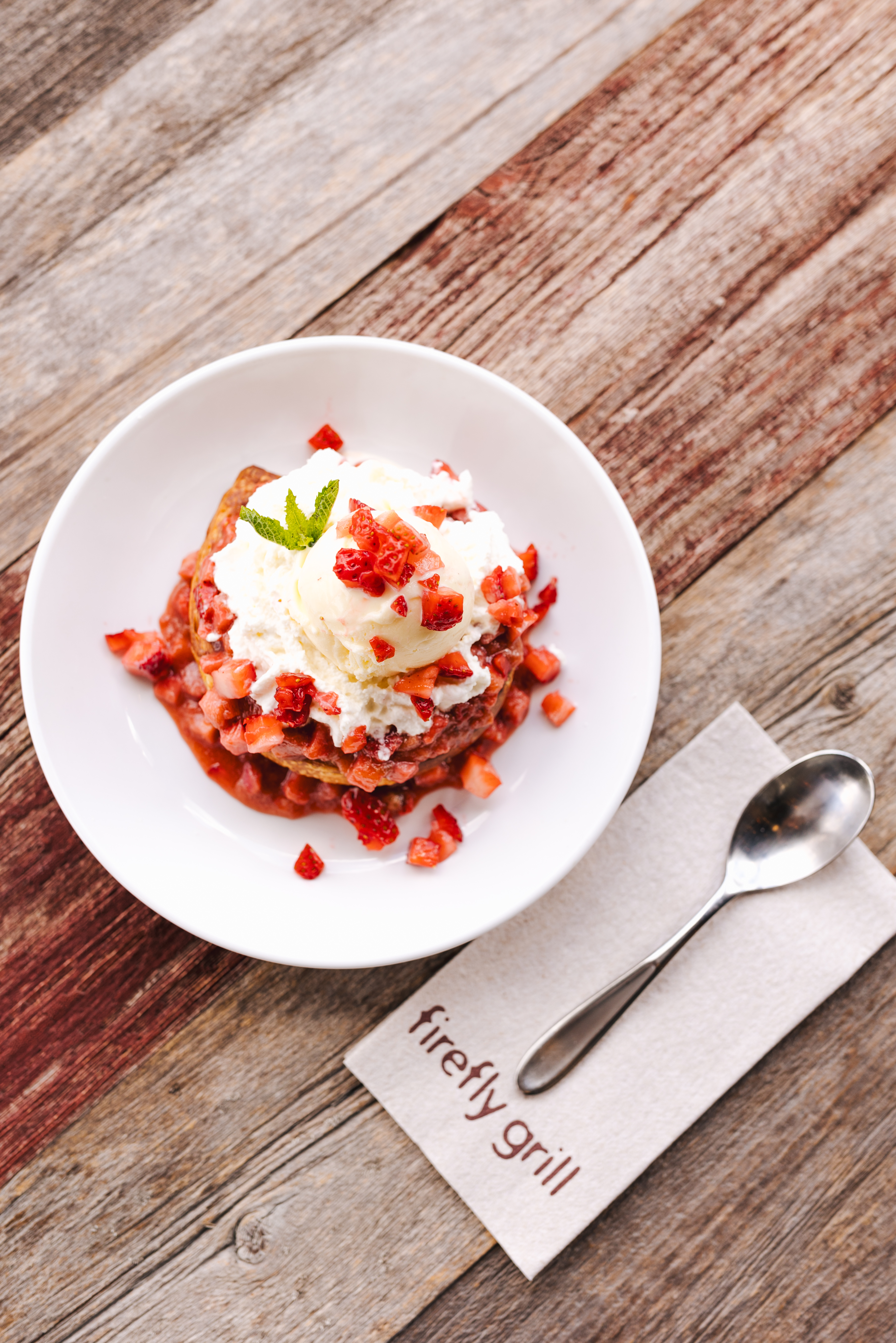 a plate of food with a spoon and a napkin