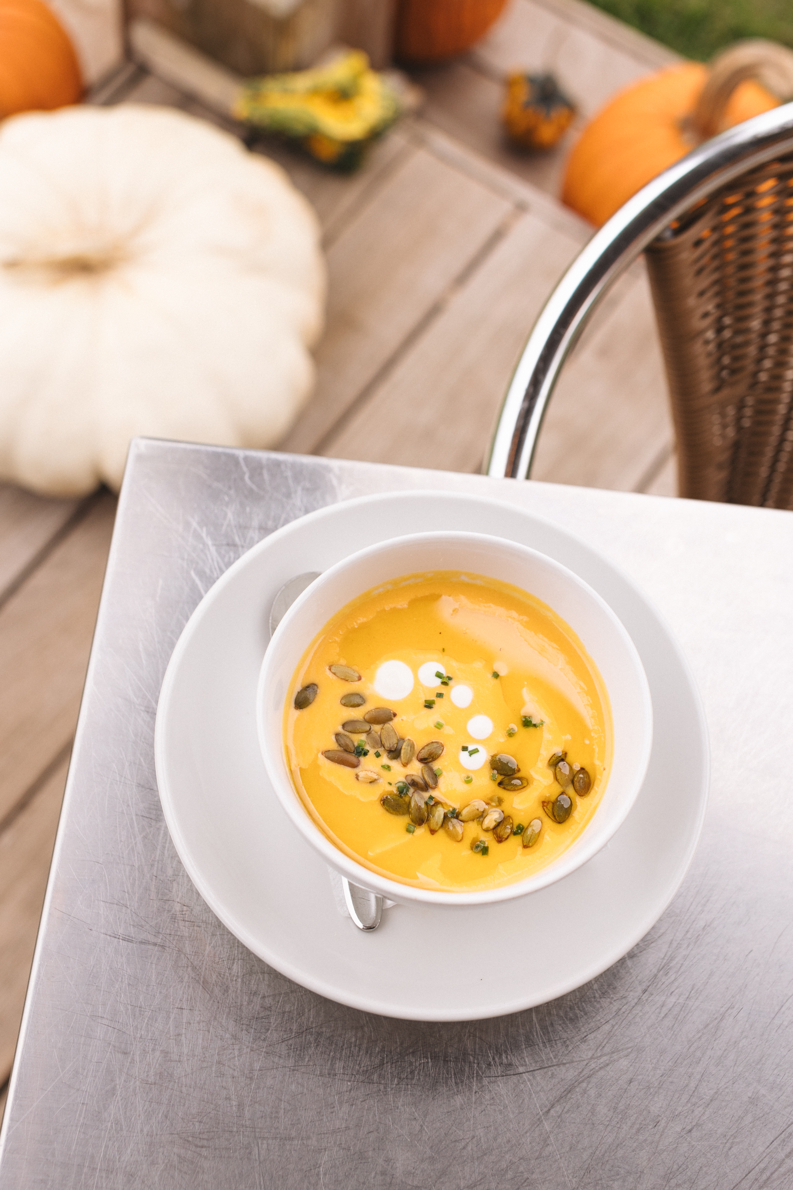 a cup of soup on a plate