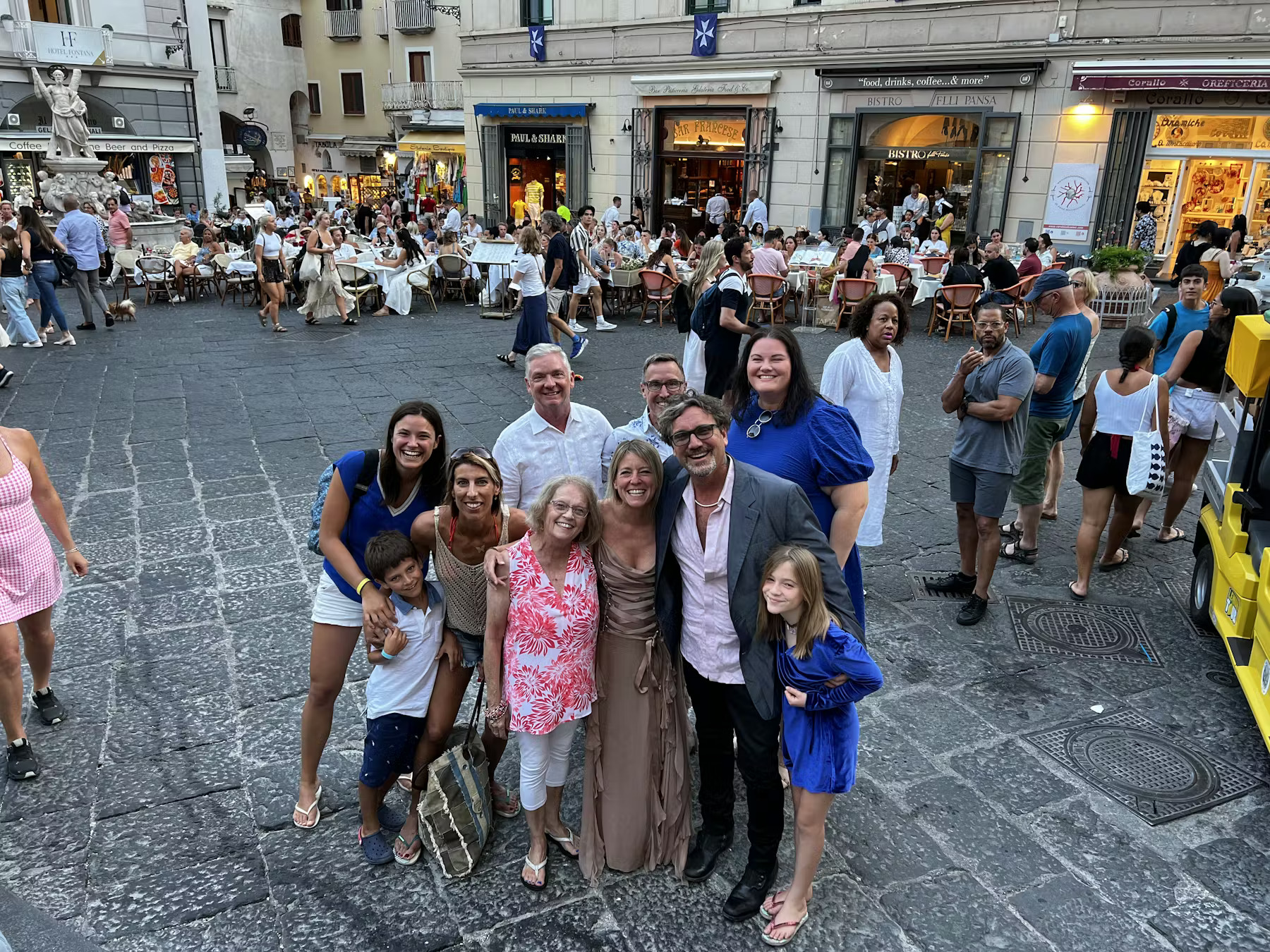 a group of people walking in front of a crowd posing for the camera