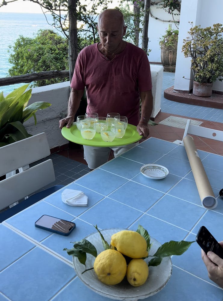 a person sitting at a table with plates of food