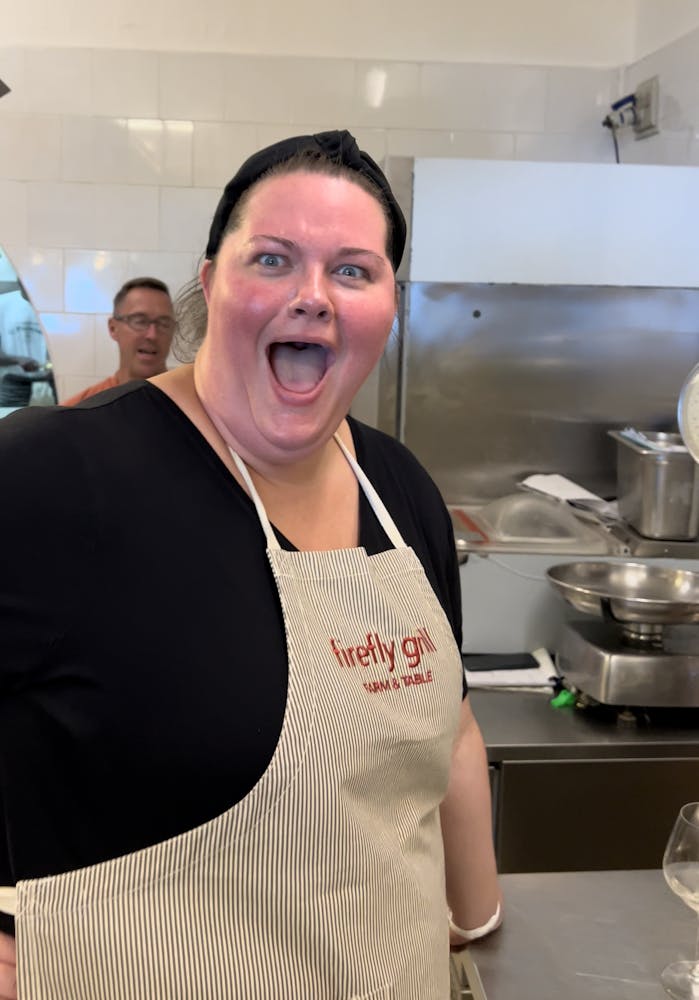 a woman preparing food in a kitchen
