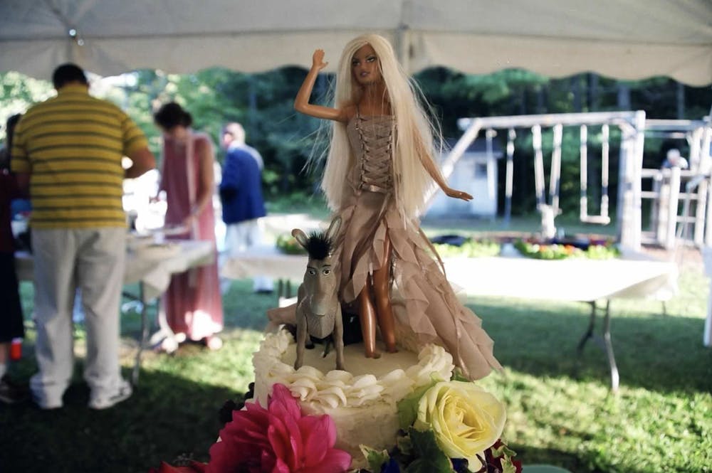 a person standing in front of a cake