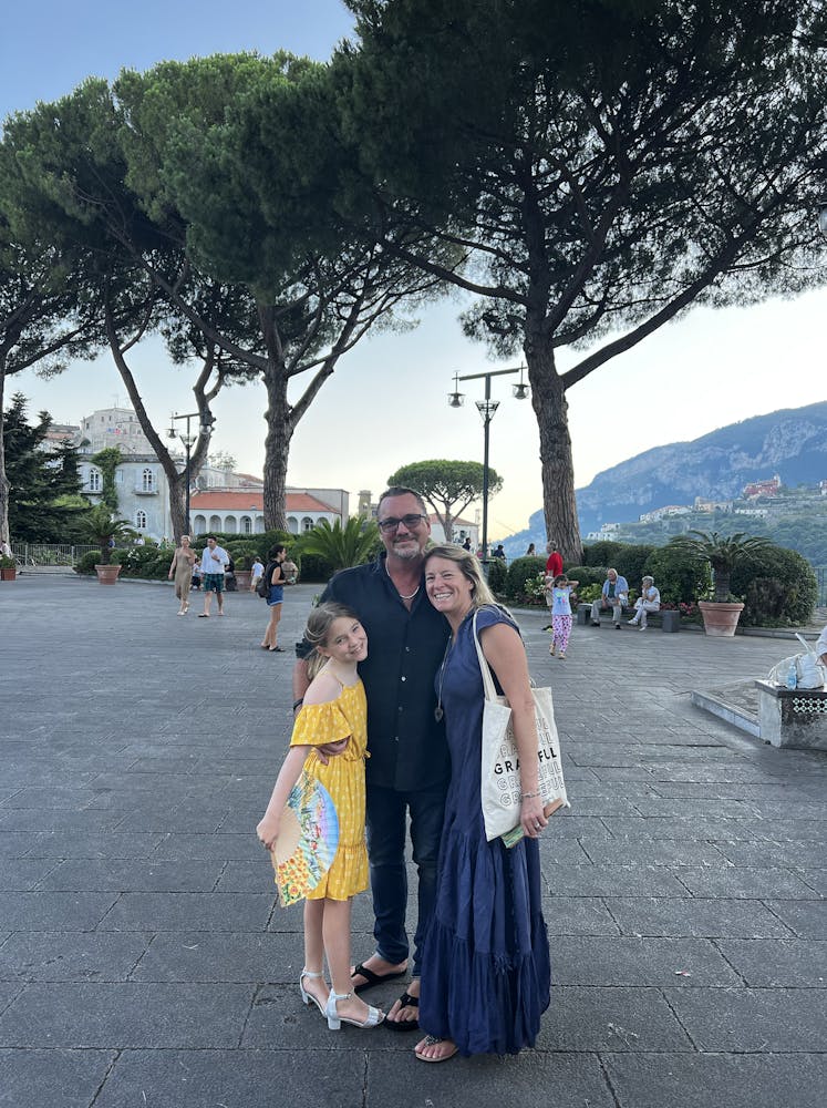 a man and a woman standing next to a tree