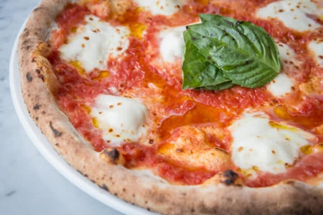 a pizza sitting on top of a white plate