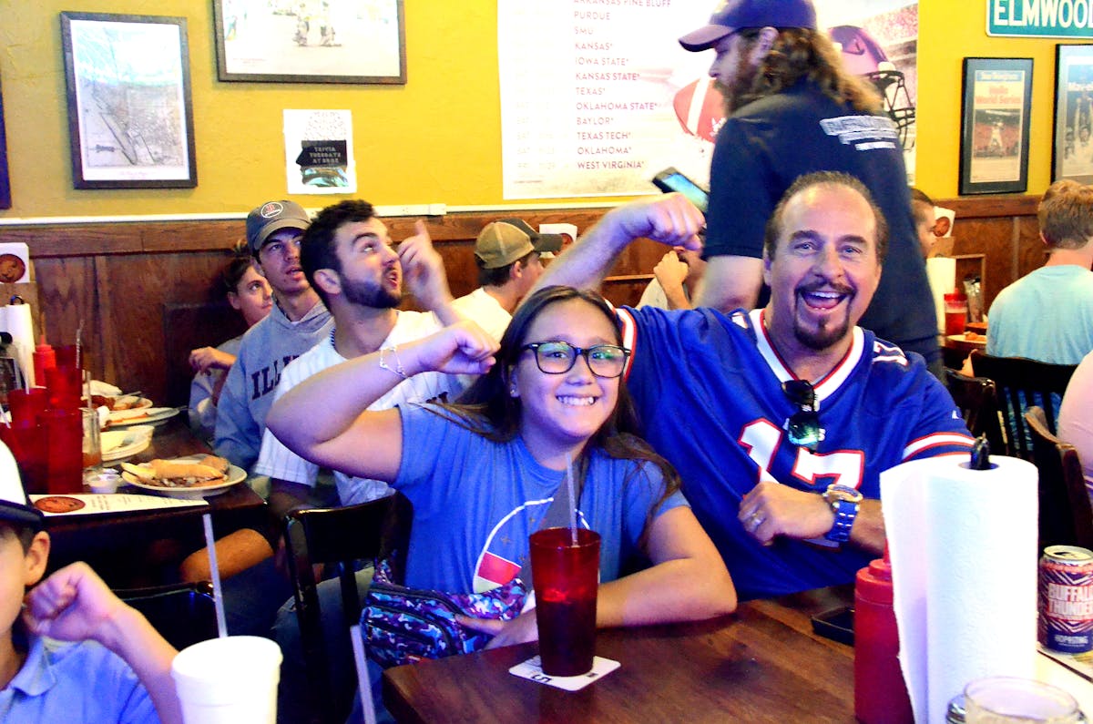 a group of people celebrating for a team