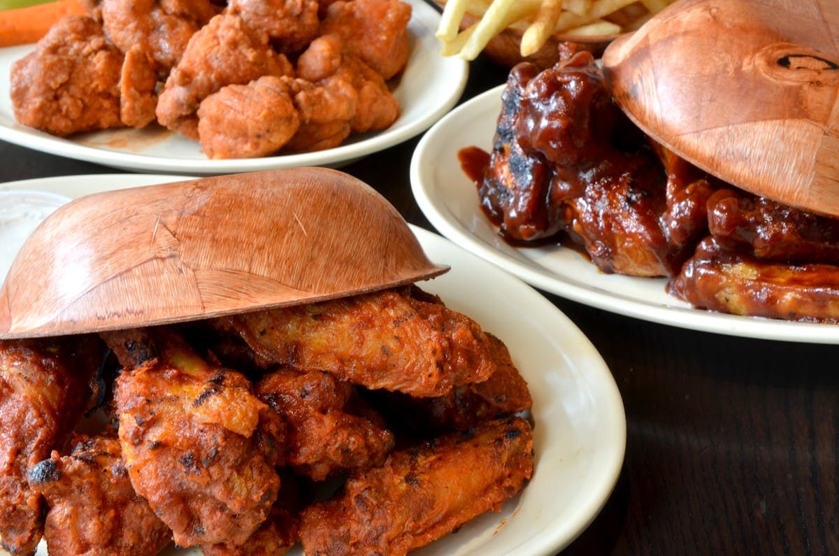 three plates of food with different servings of chicken and fries