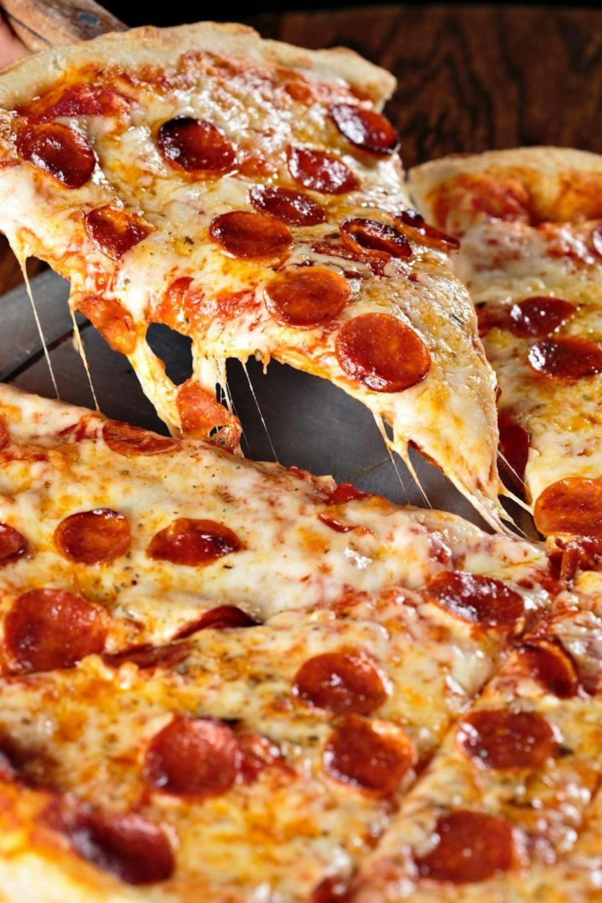 a close up of a slice of pepperoni pizza on a tray