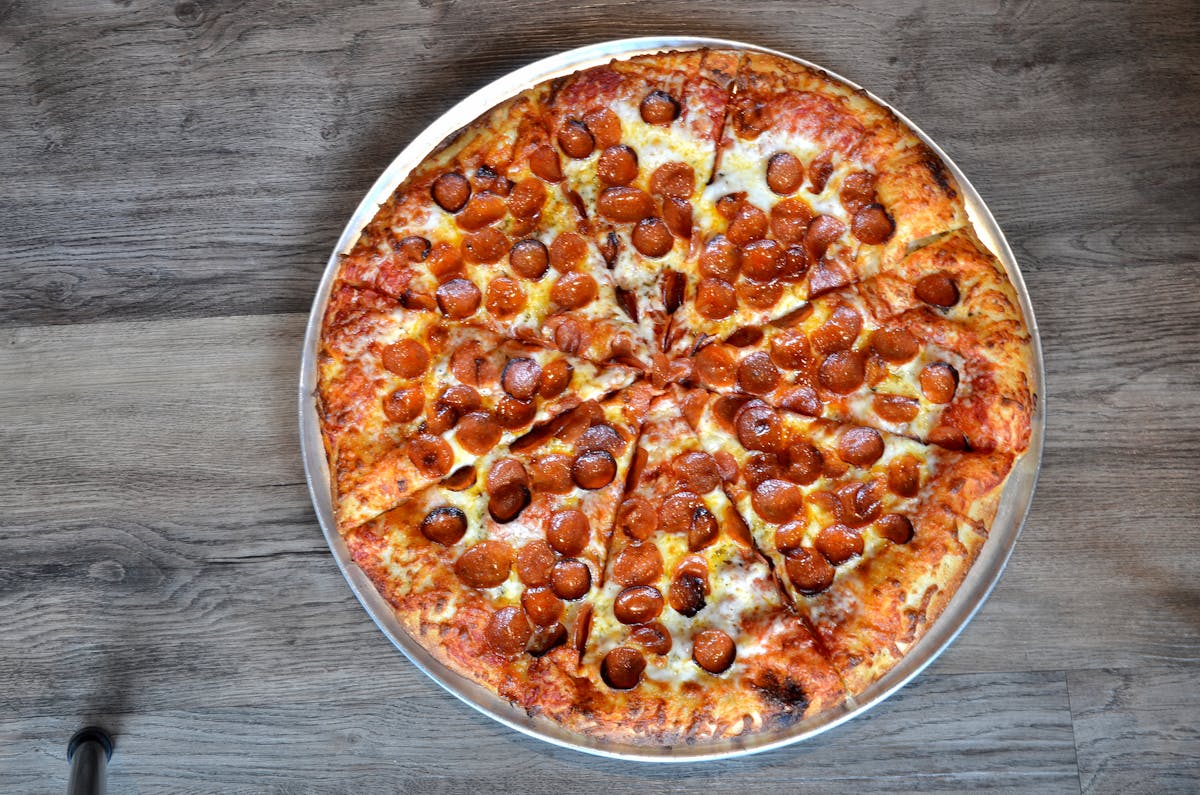 a crusty pepperoni pizza from a top view.