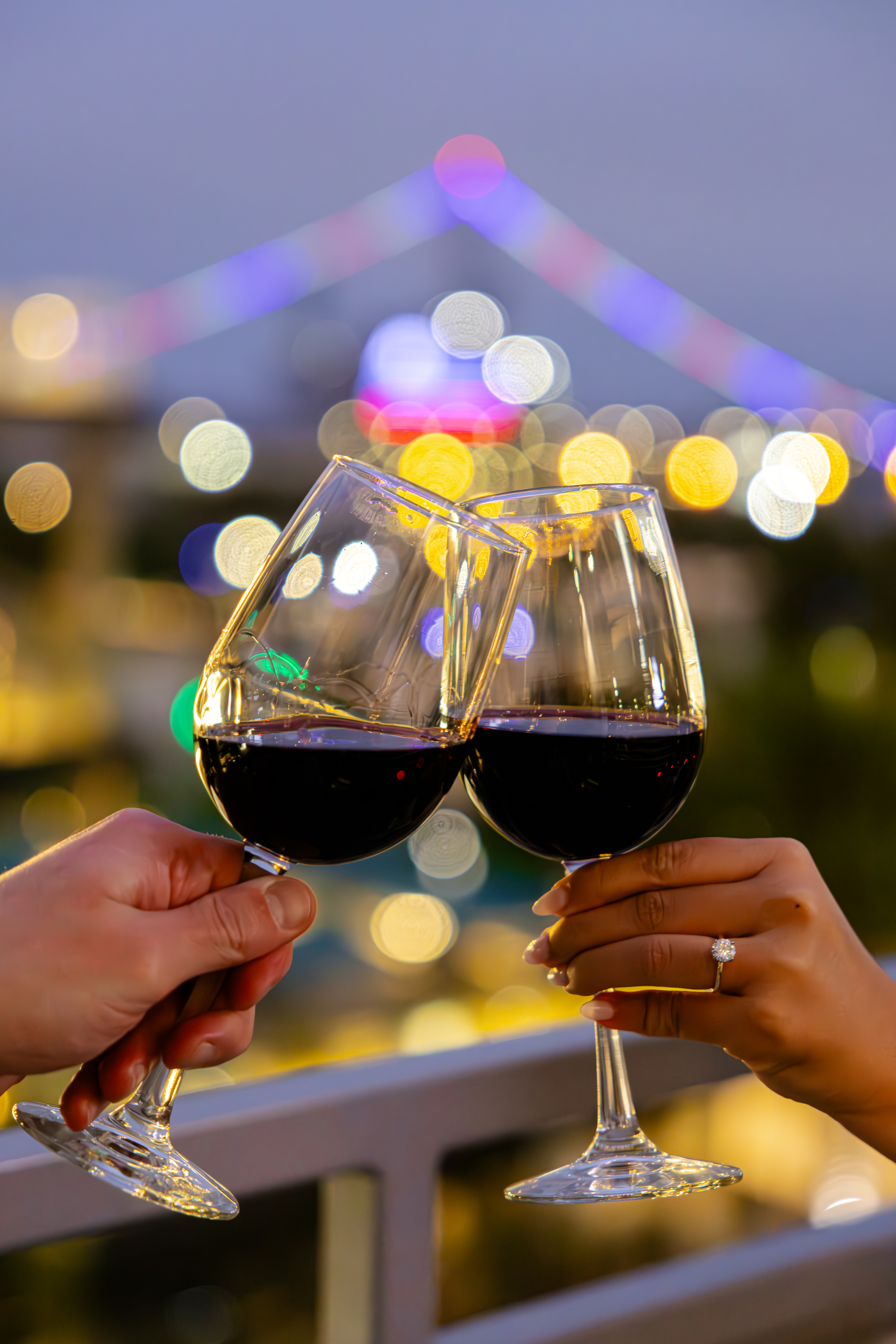 a person holding wine glasses