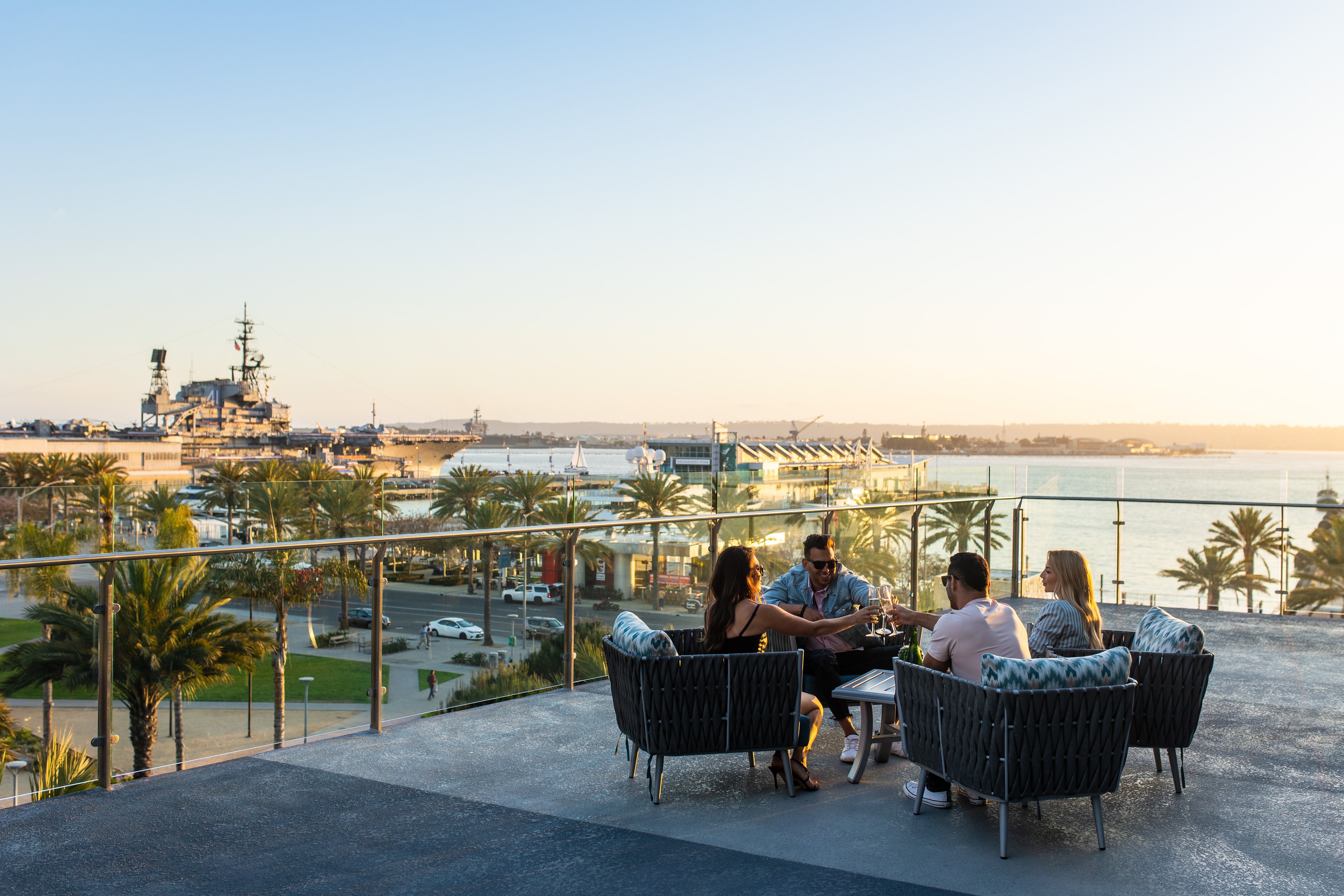a group of people standing next to a body of water