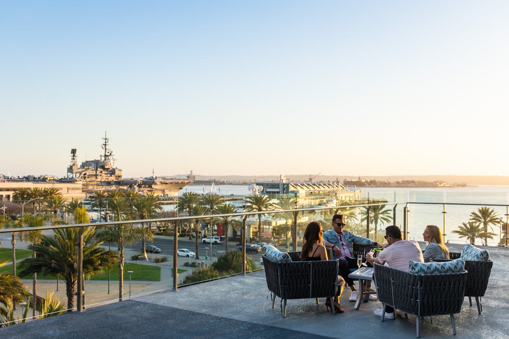 a group of people standing next to a fence