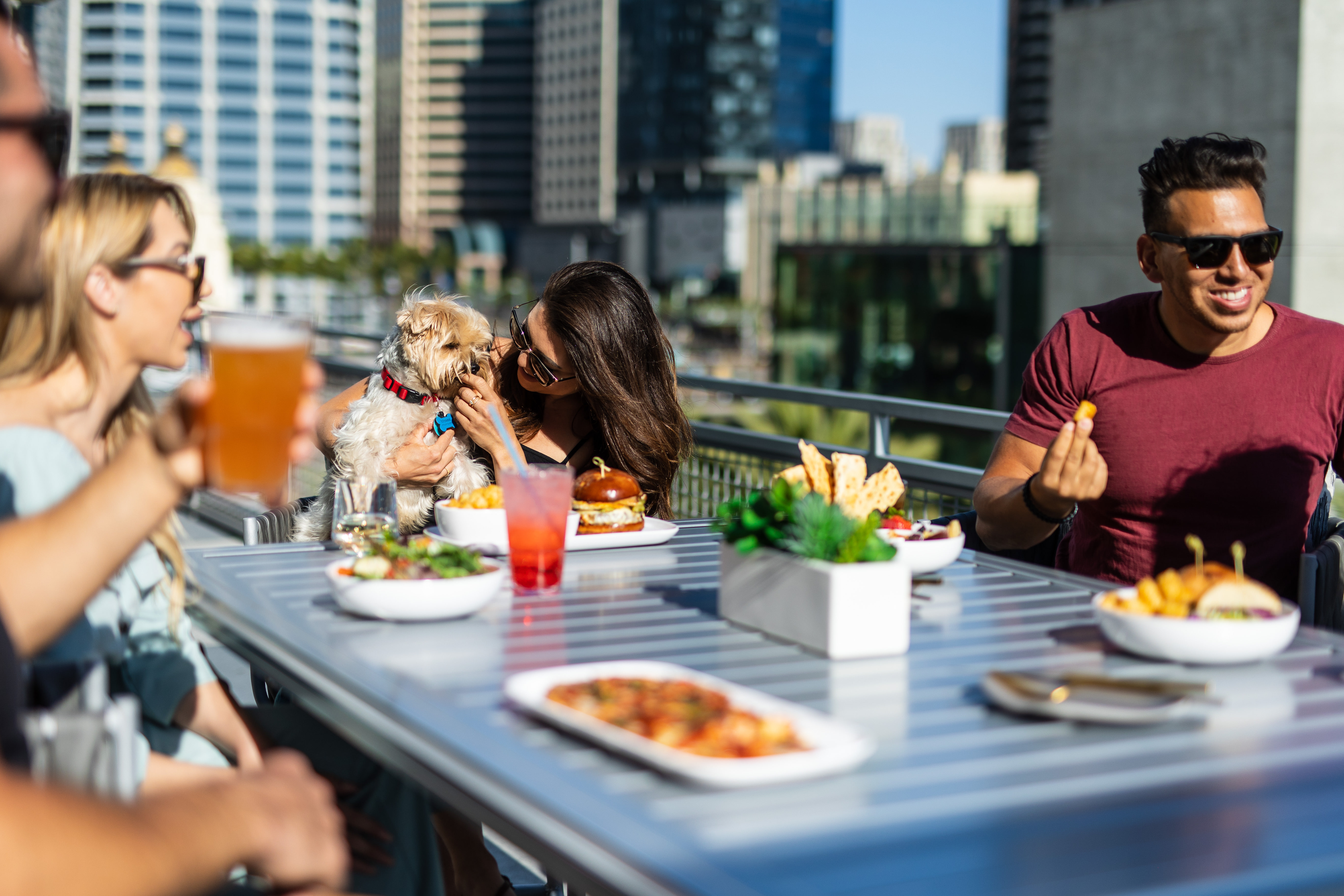 a group of people sitting at a table with food