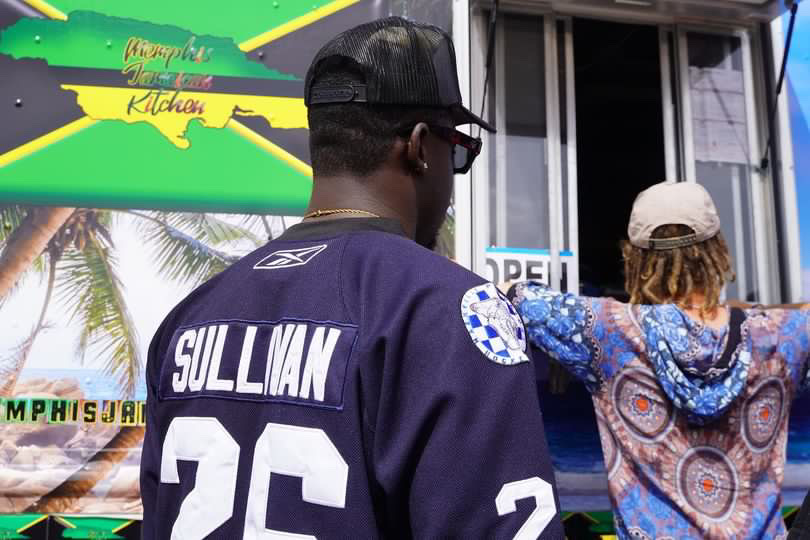 a man wearing a hat and sunglasses