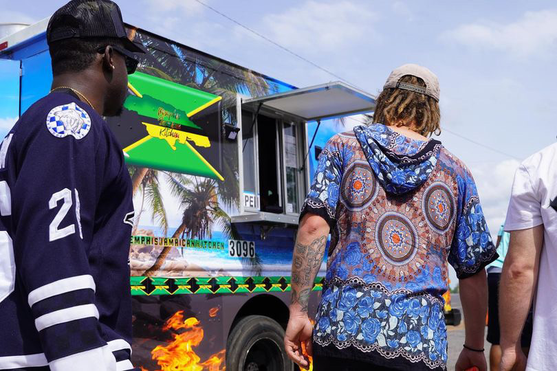 a group of people riding on the back of a truck