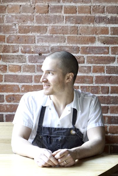 a person sitting in front of a brick wall