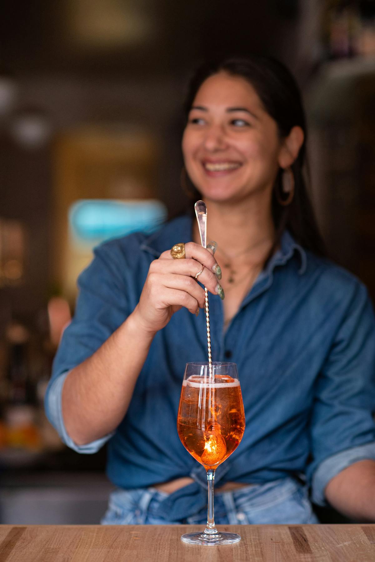 a bartender stirring an Italian cocktail