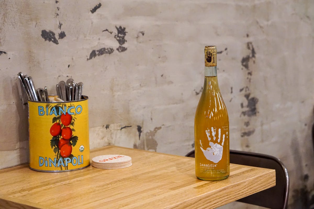 a bottle of wine sitting on top of a wooden table