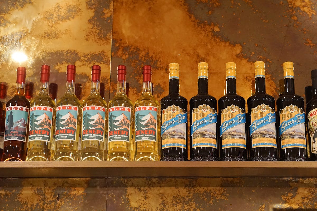 a close up of Italian amaro bottles on display