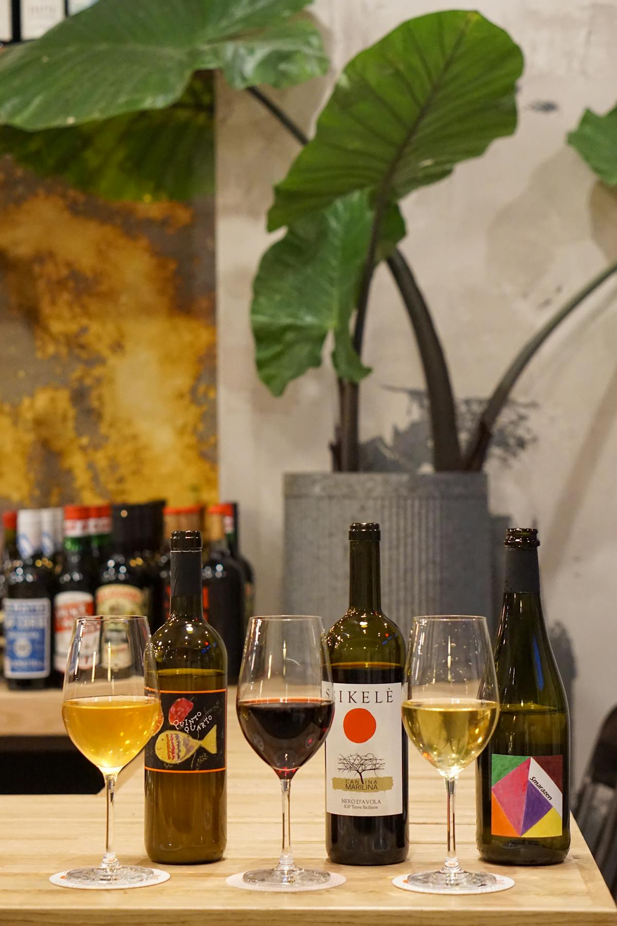 bottles of natural wines next to wine glasses