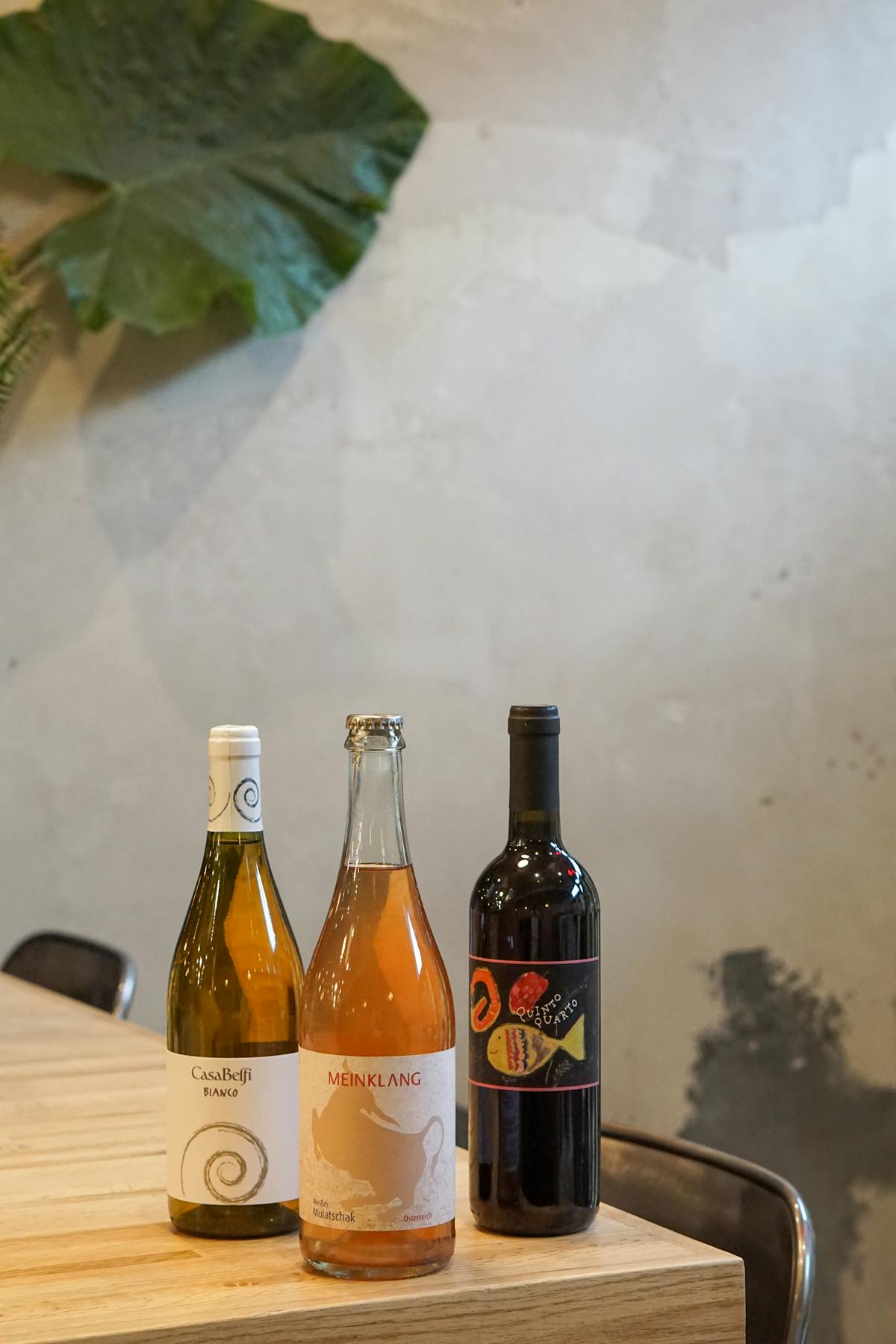 a close up of three bottles of natural orangewine
