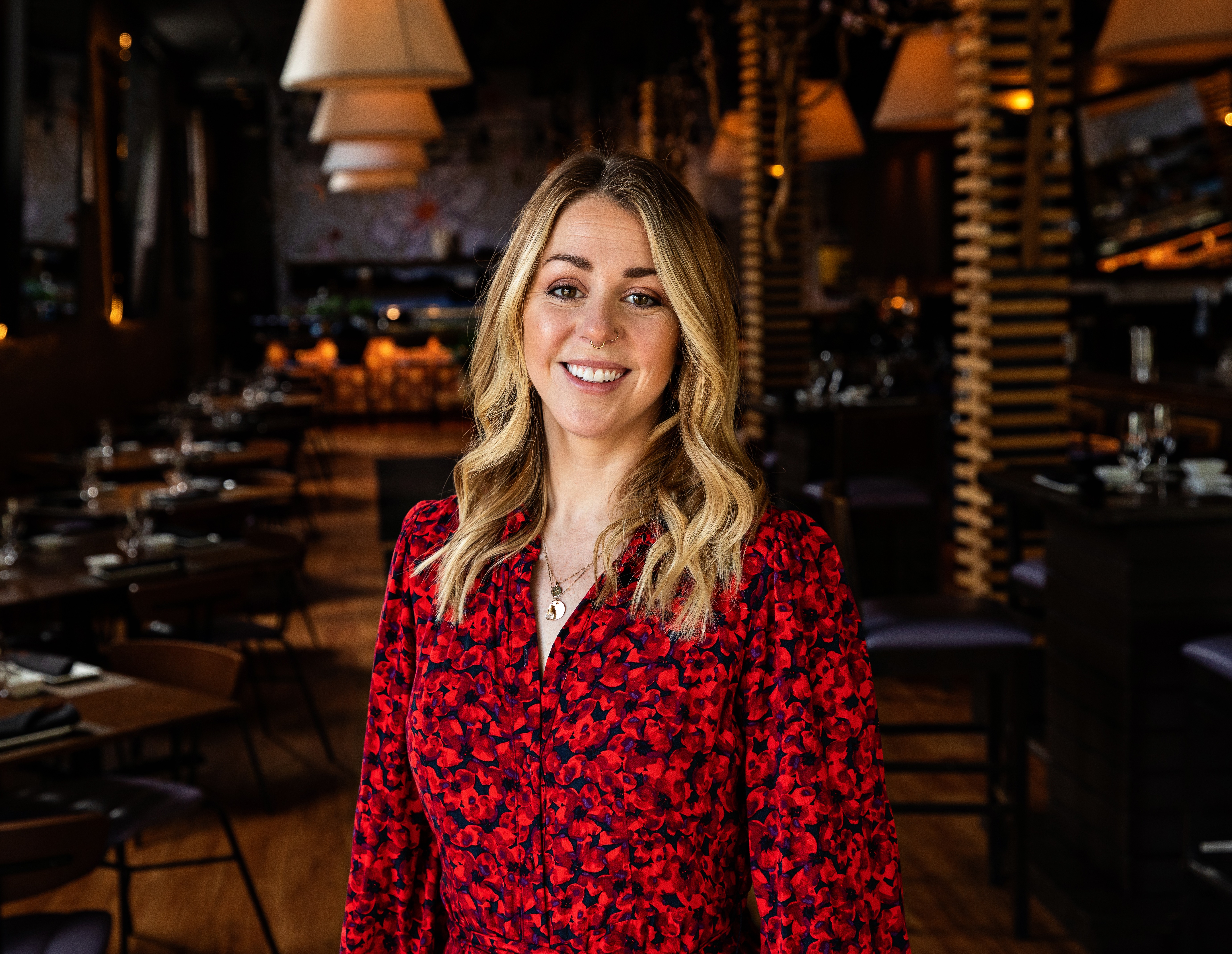 a woman standing in front of a restaurant