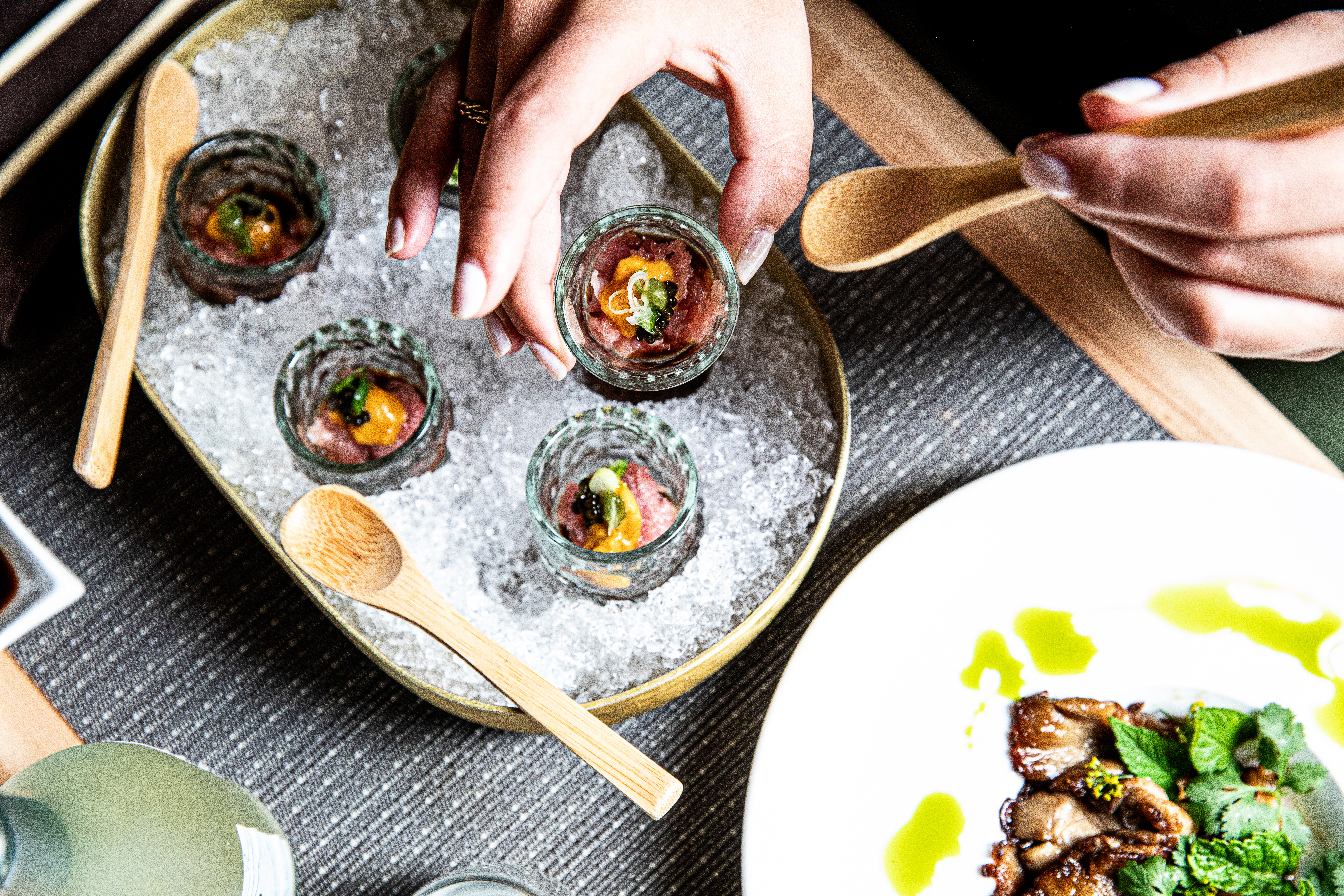 a person sitting at a table with a plate of food