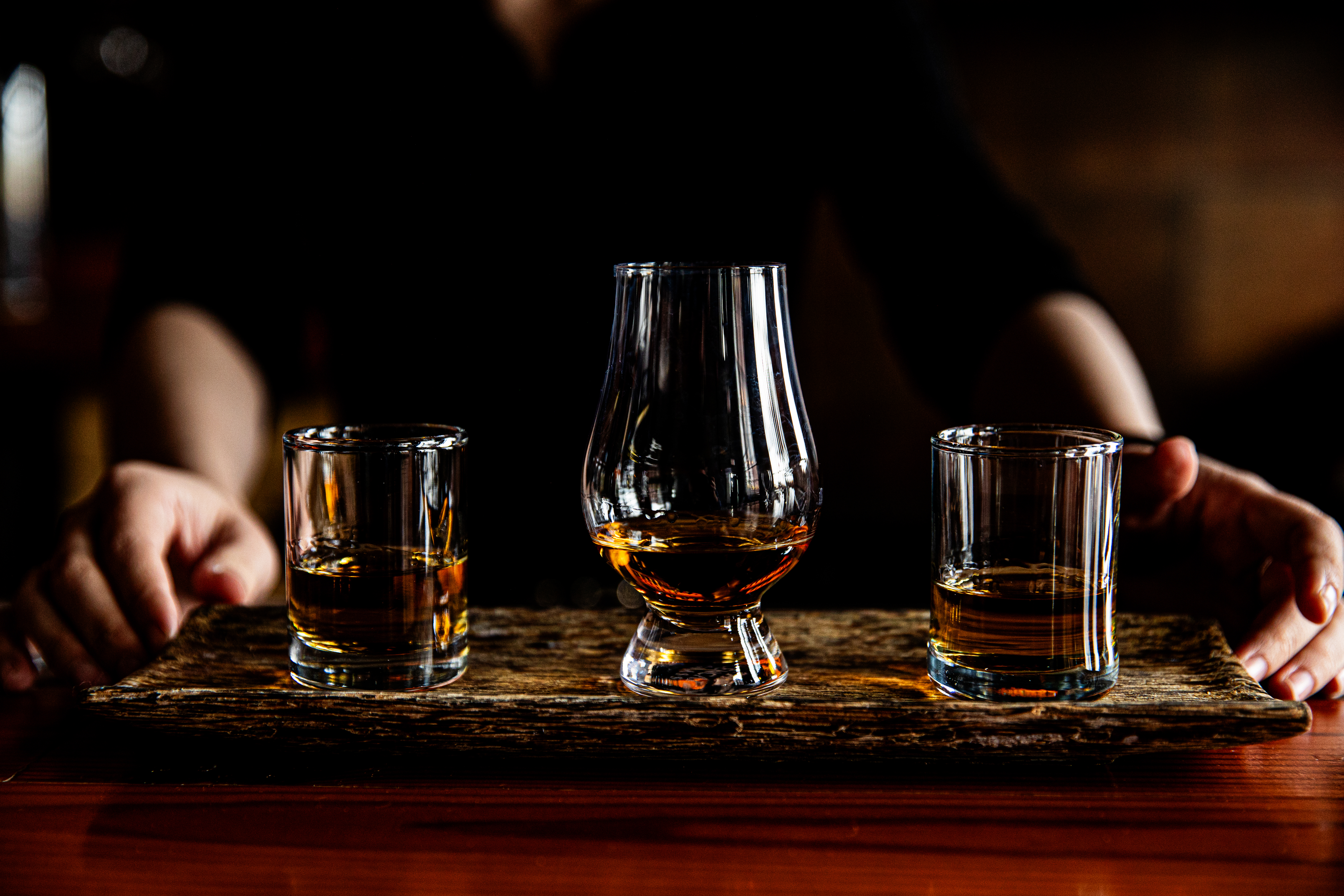 a hand holding a glass of wine