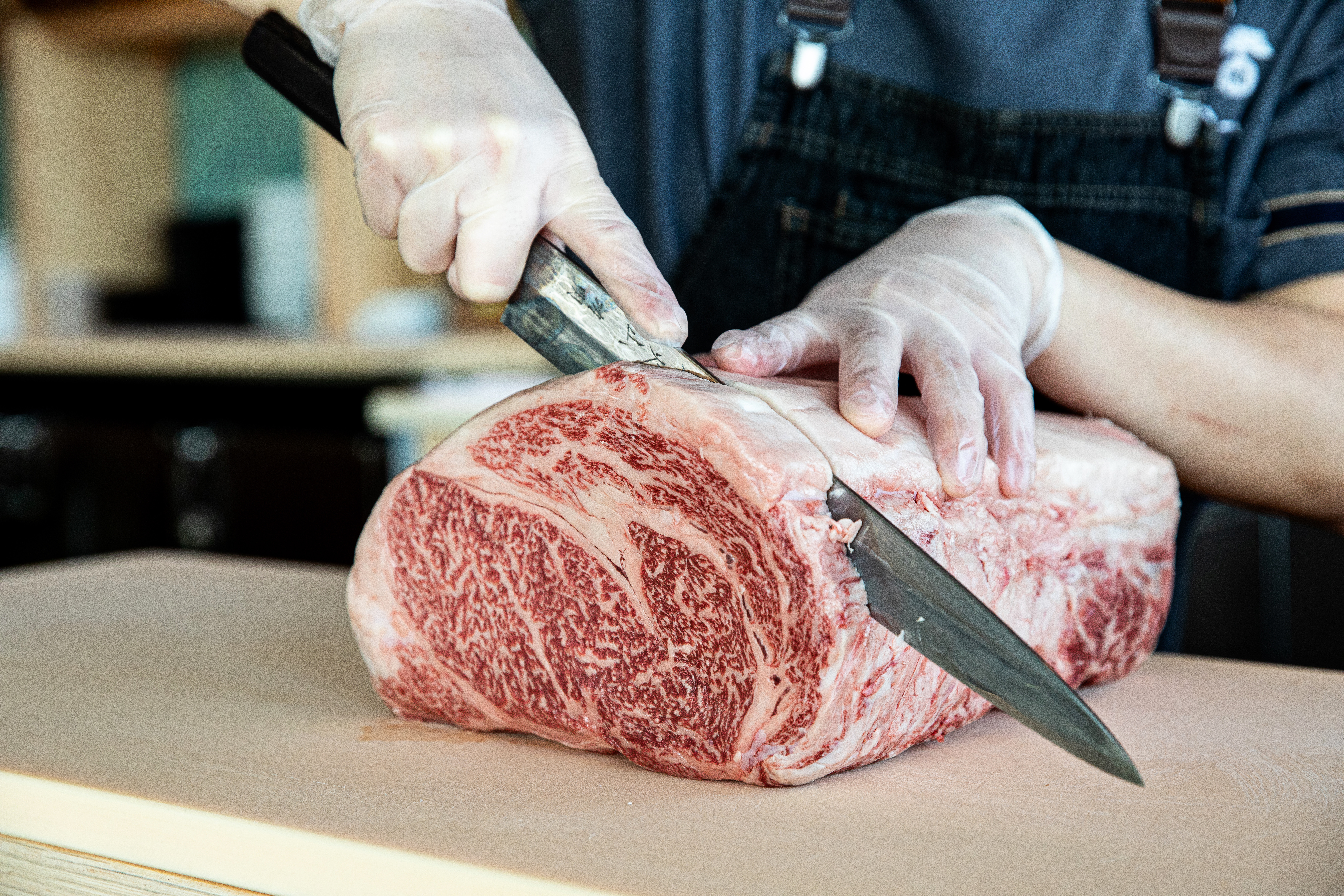 a person cutting a piece of cake on a table