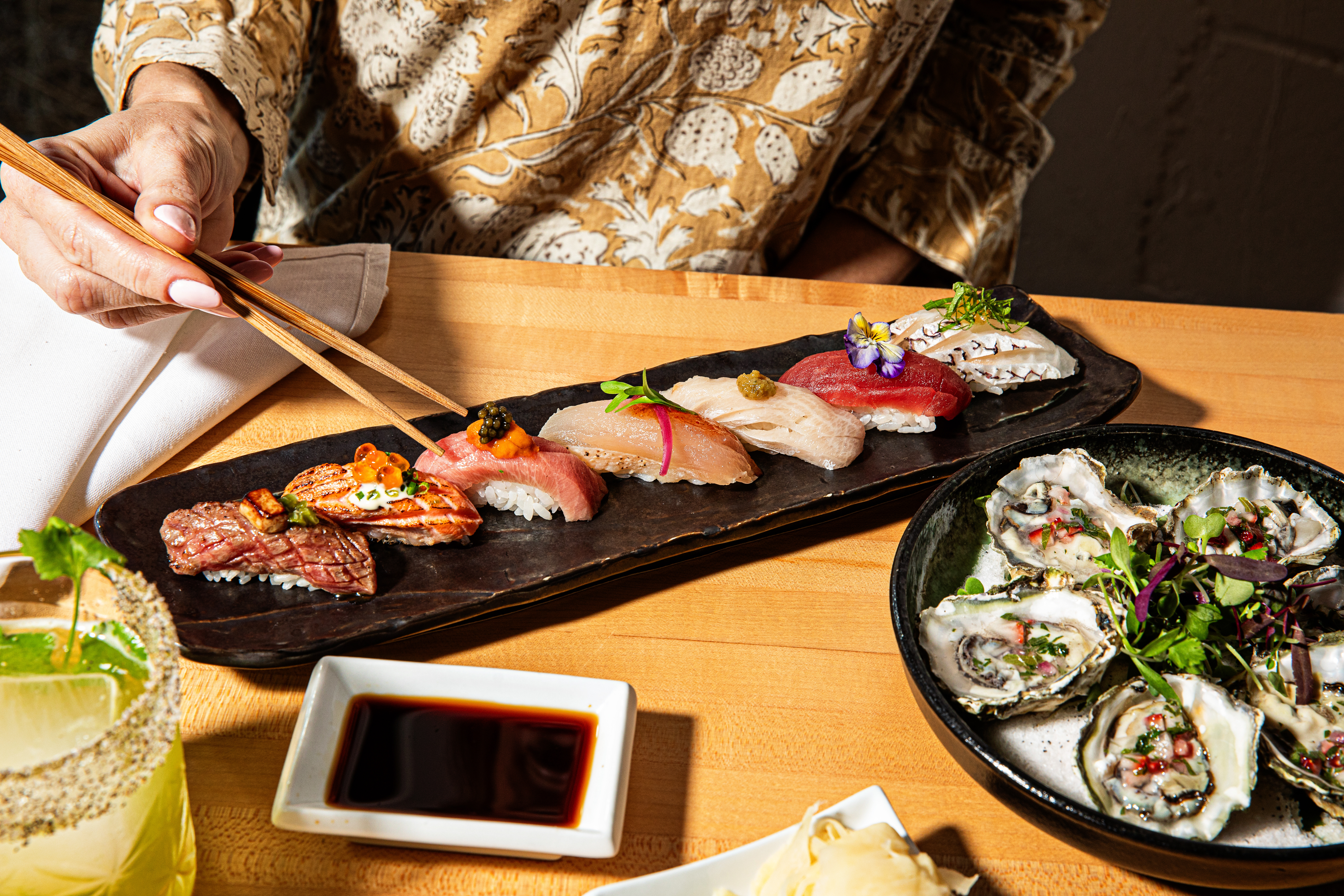 a person sitting at a table with a plate of food