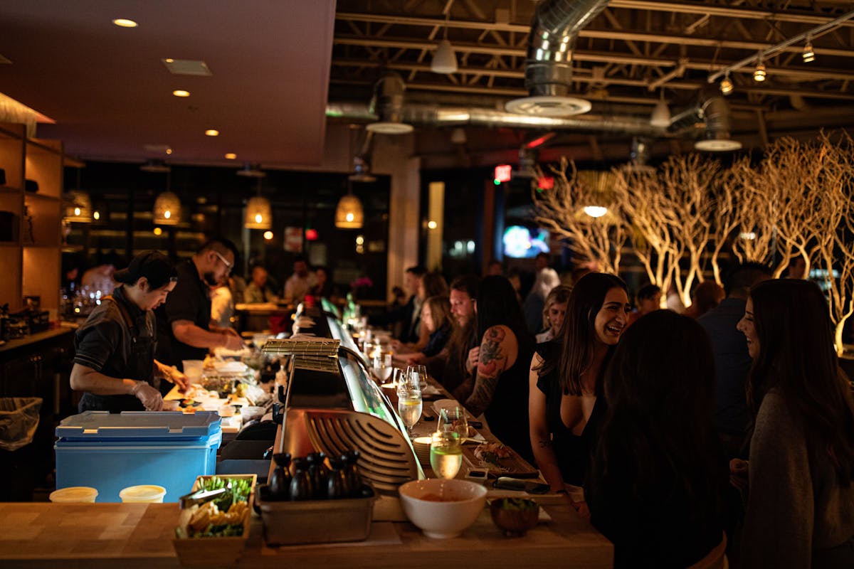 a group of people sitting at a table in a restaurant