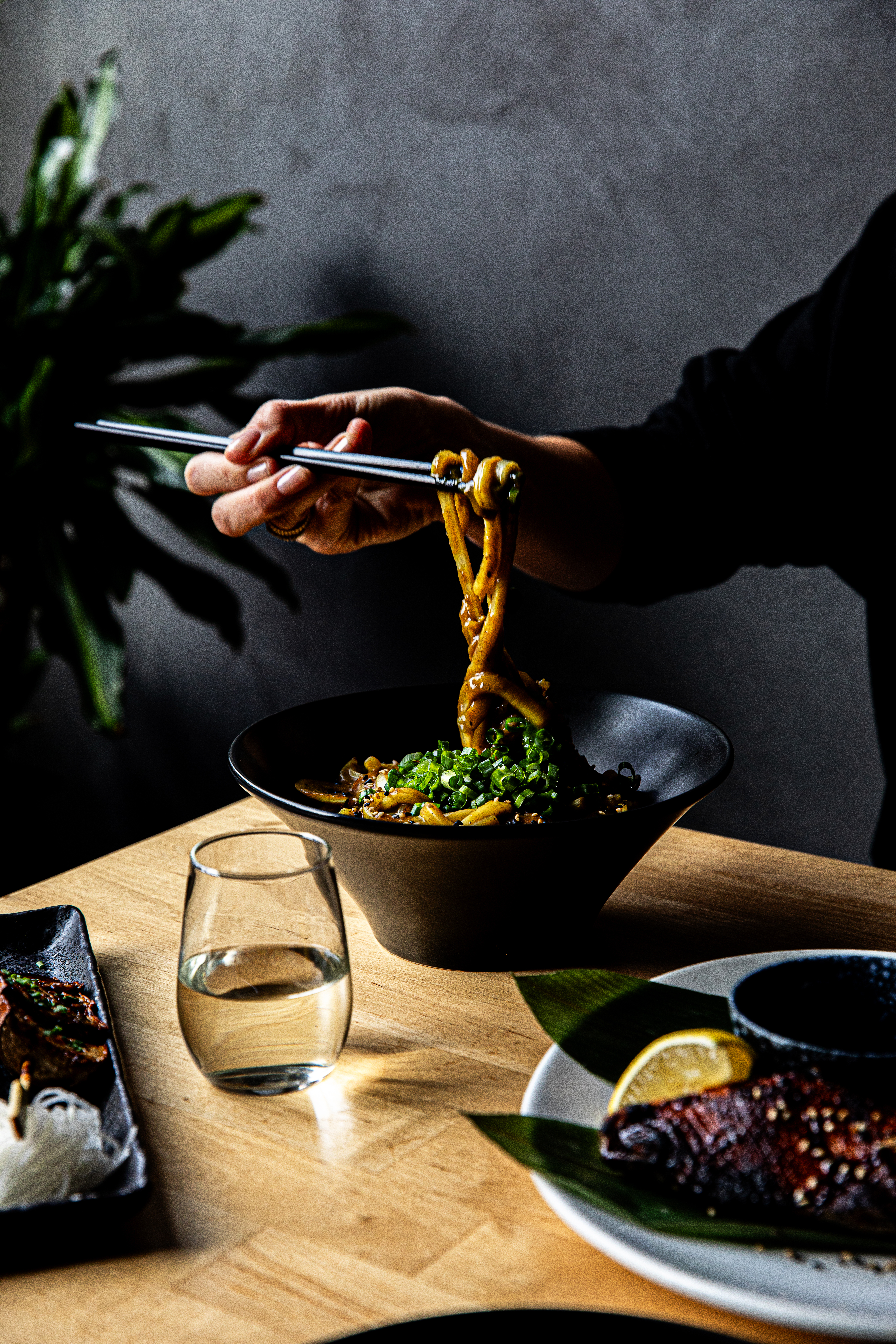 a person holding a bowl of food on a table