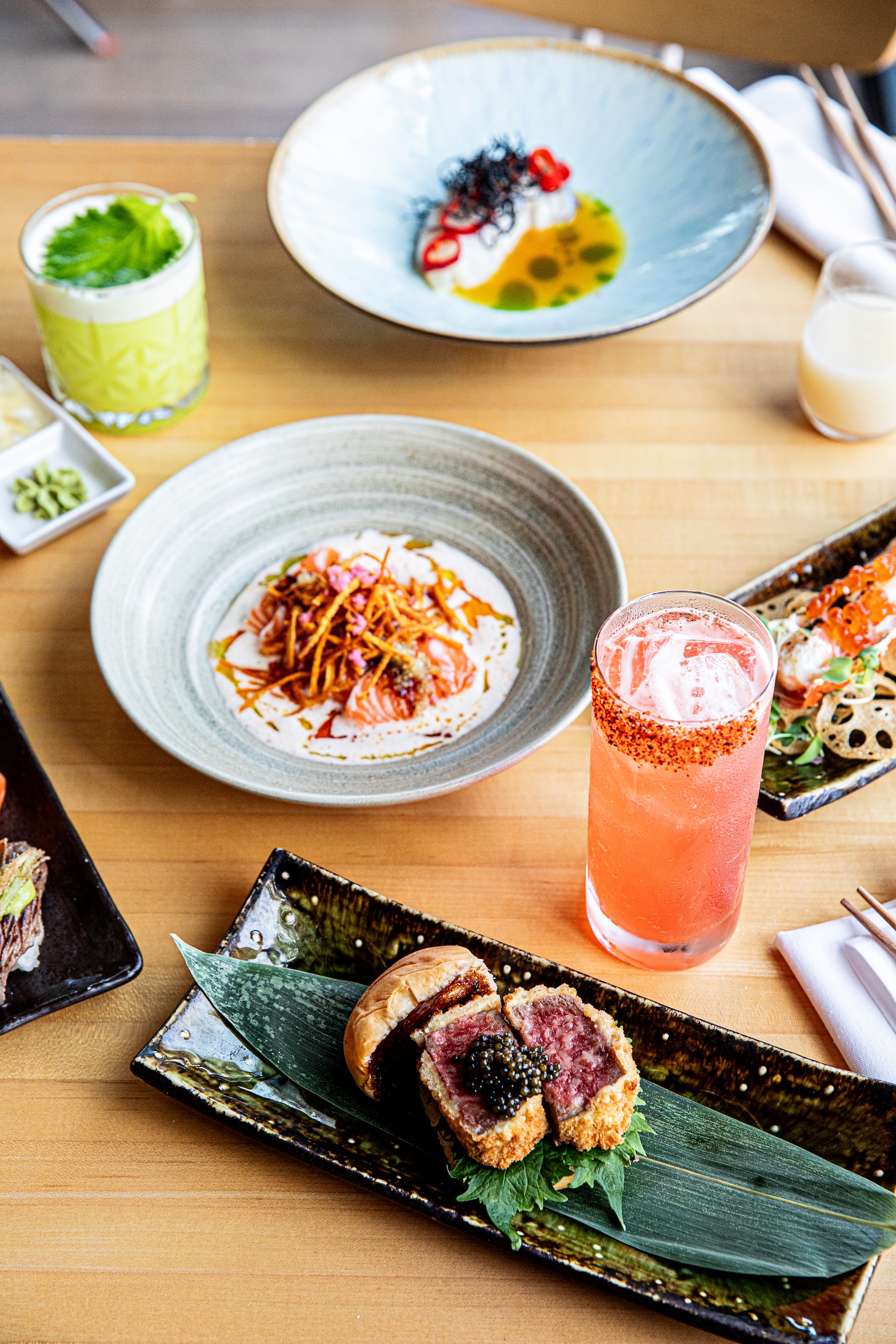 a table with plates of food and drinks
