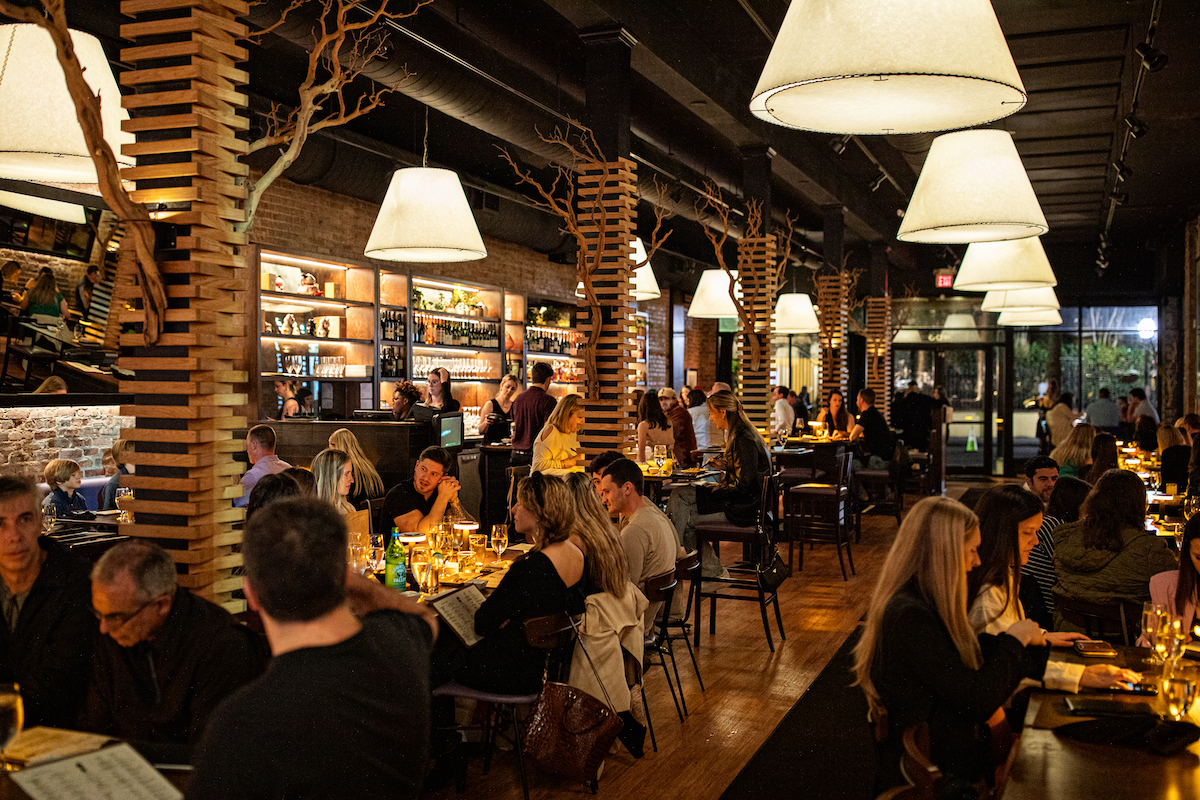 a group of people sitting at a table in a restaurant