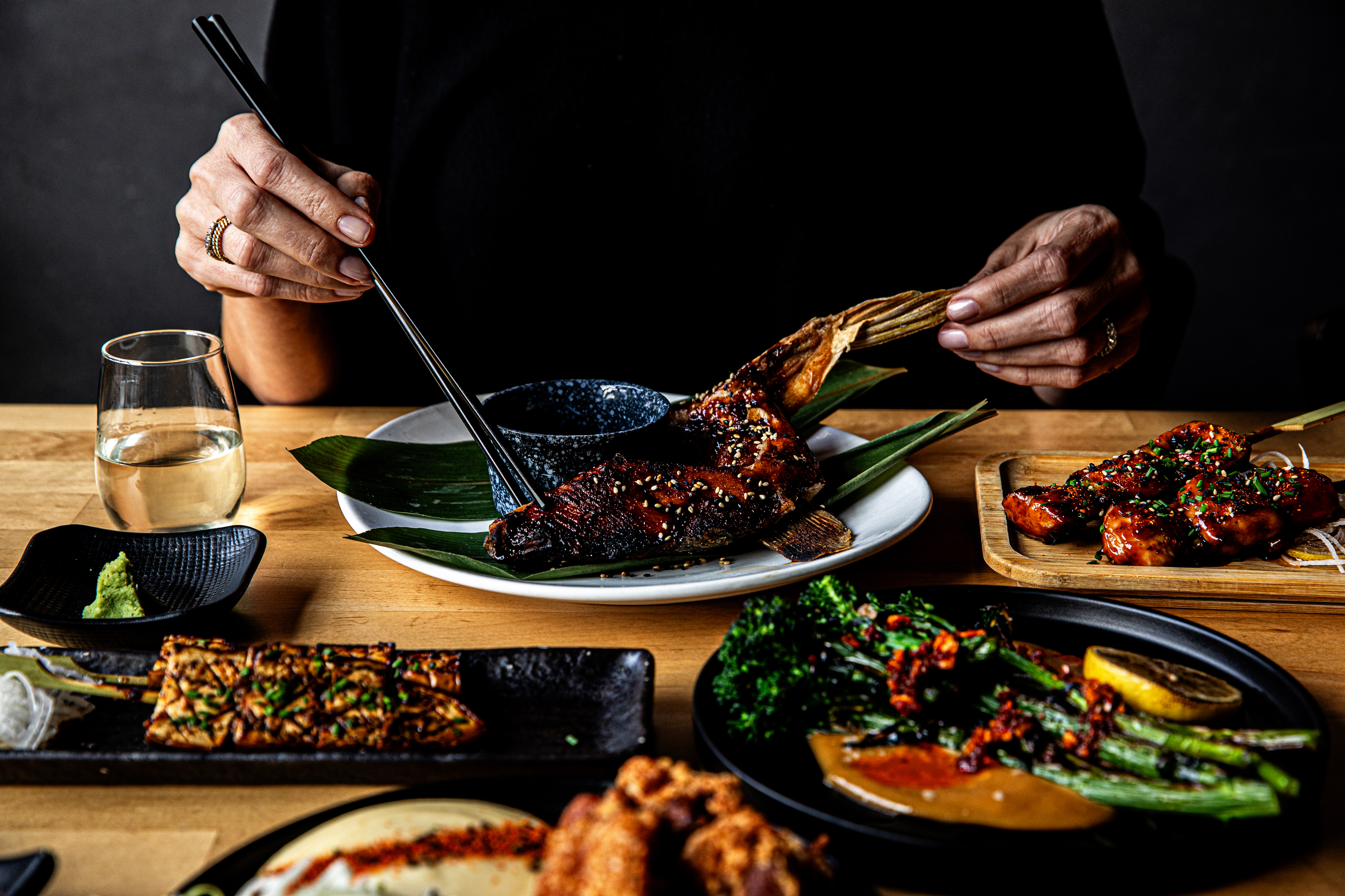 a person sitting at a table with a plate of food