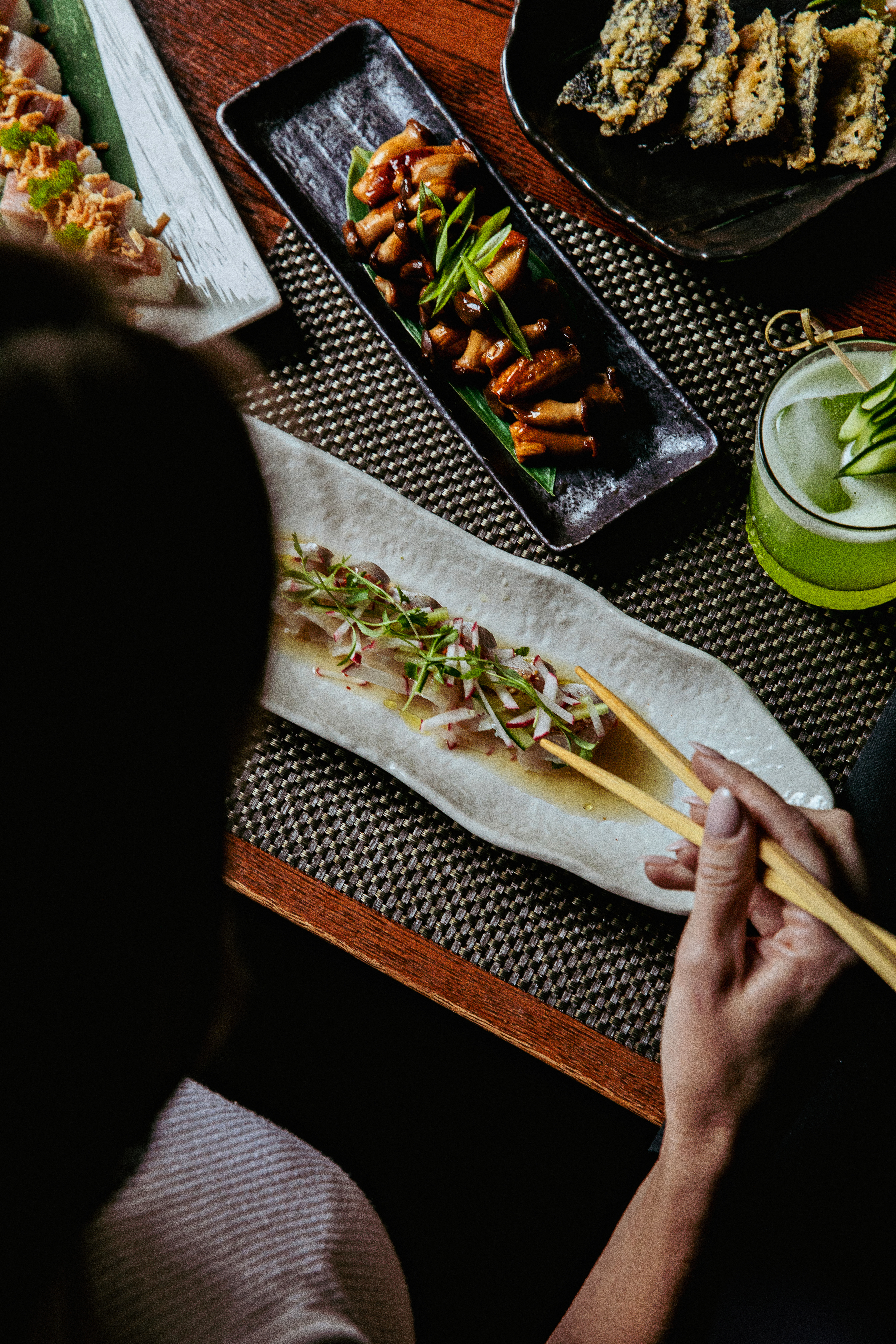 a group of people sitting at a table with a plate of food