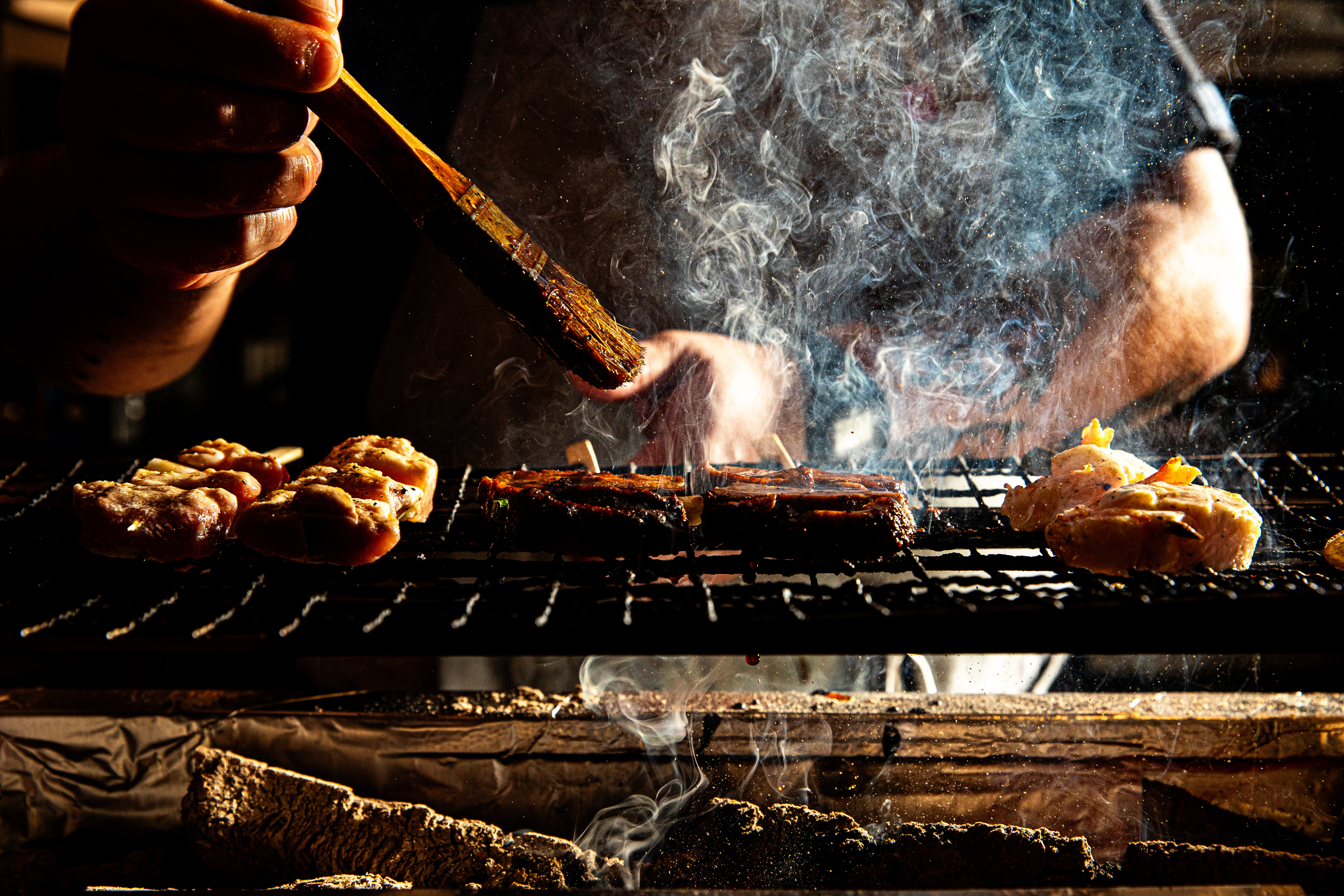 a person is cooking on a grill