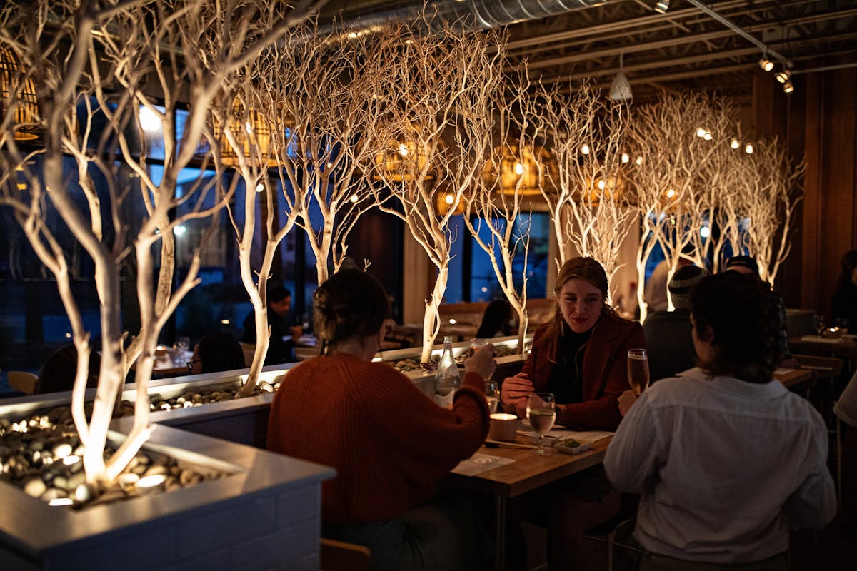 a group of people sitting at a table with wine glasses