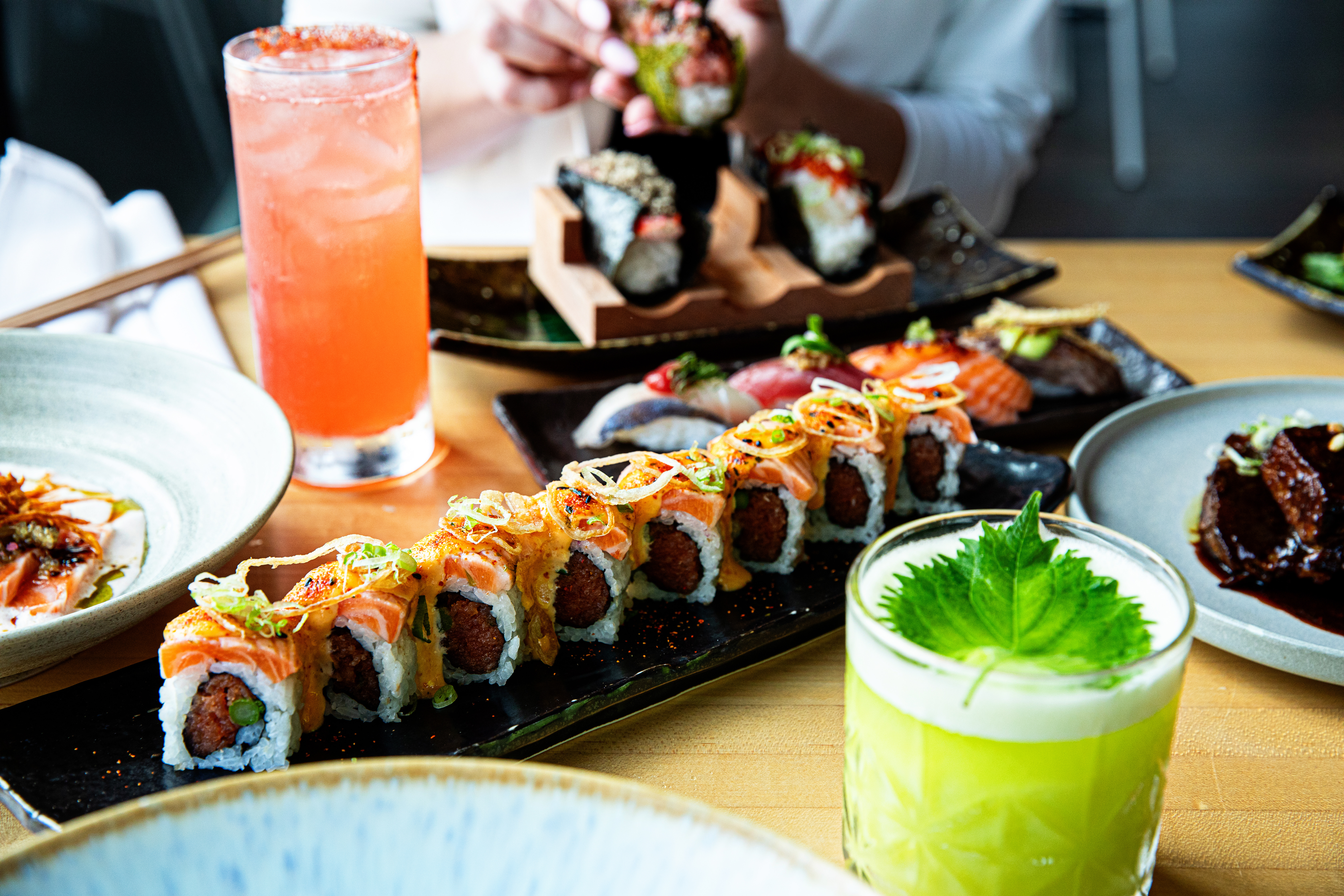 a group of people sitting at a table with a plate of food
