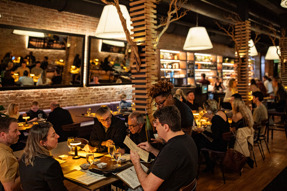 a group of people sitting at a table in a restaurant
