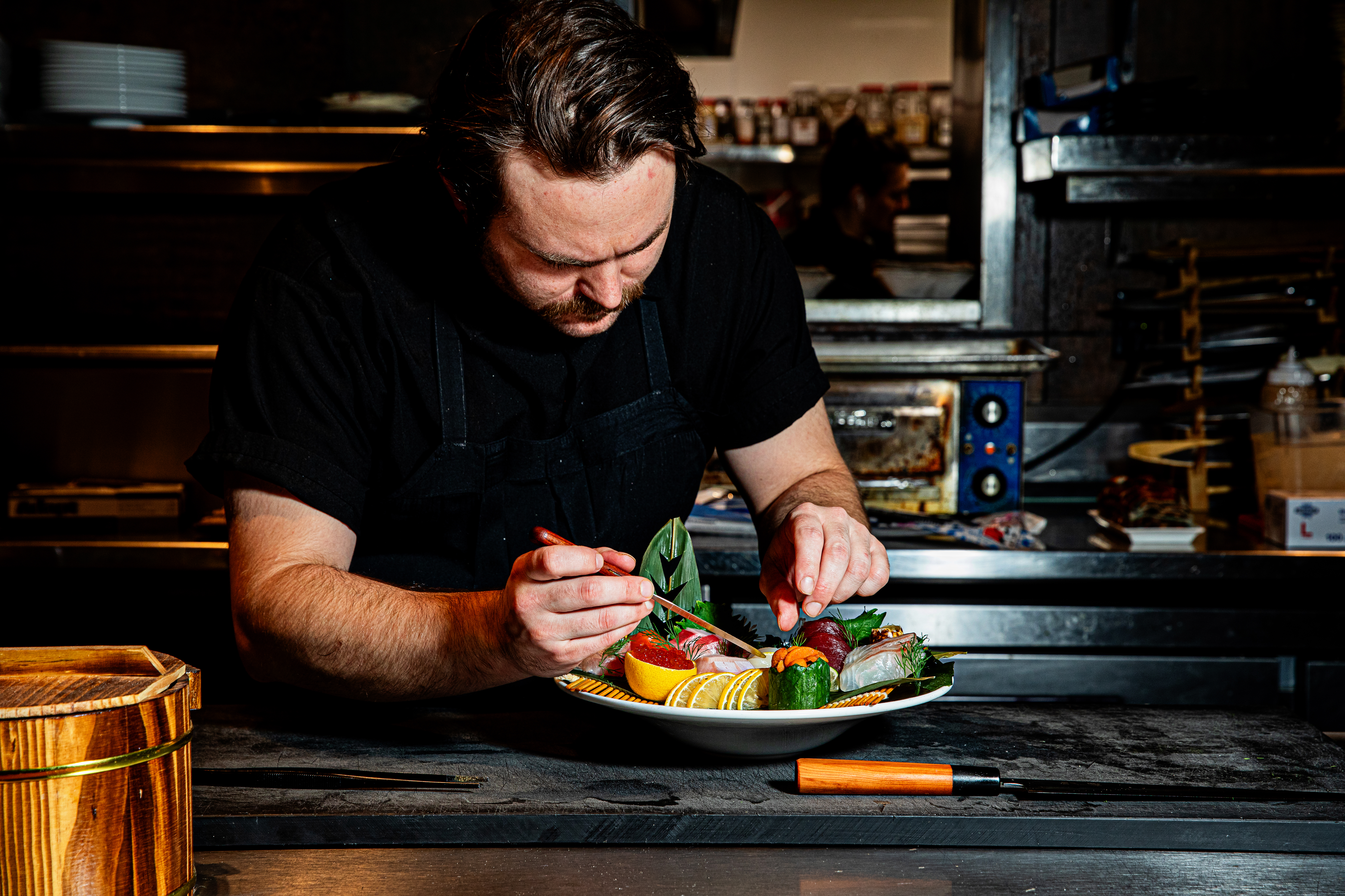 a man sitting at a table with a plate of food