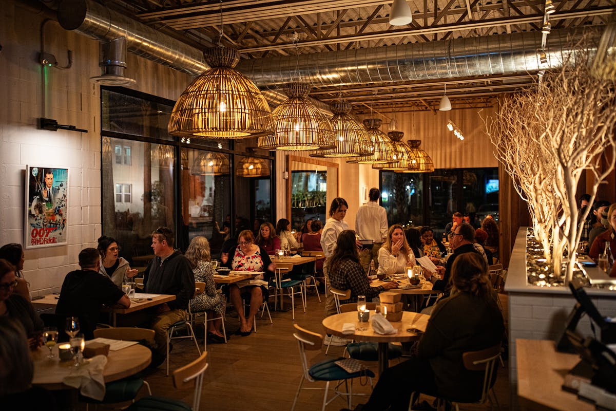 a group of people sitting at a table in a restaurant