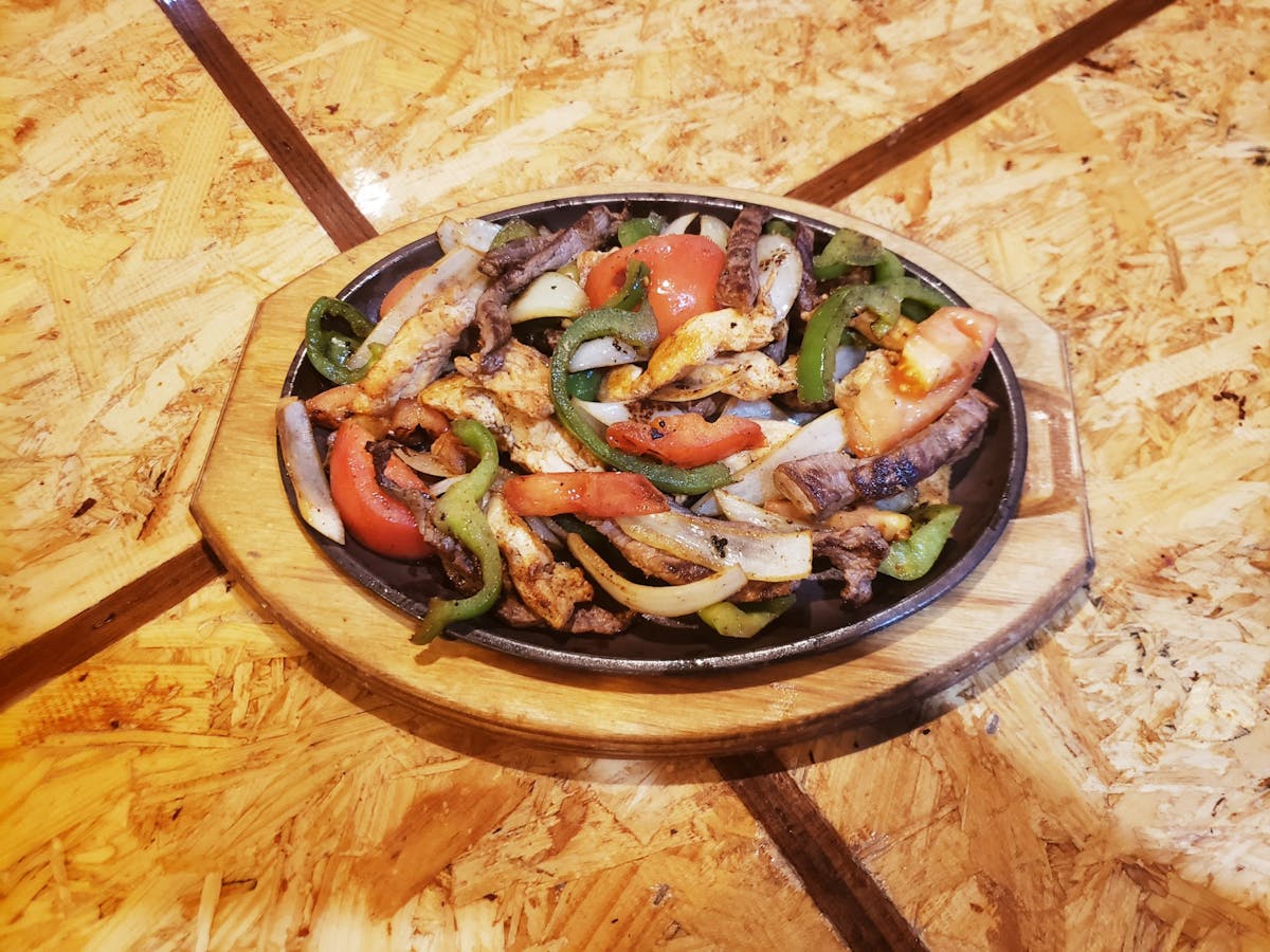 a pizza sitting on top of a wooden cutting board