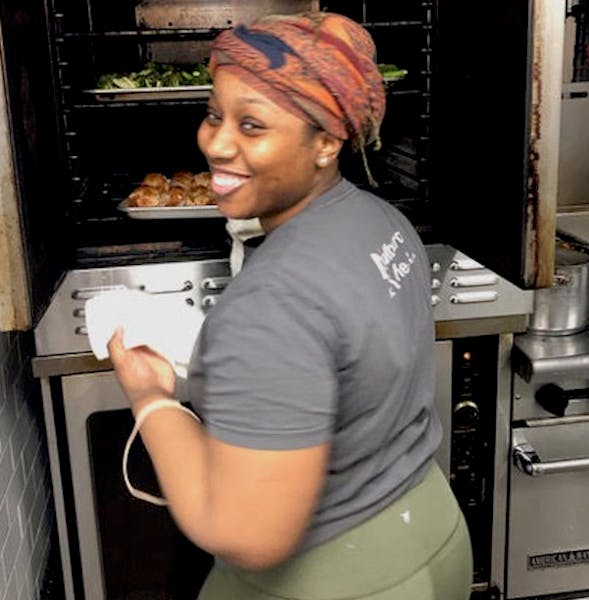 a person cooking food in the oven