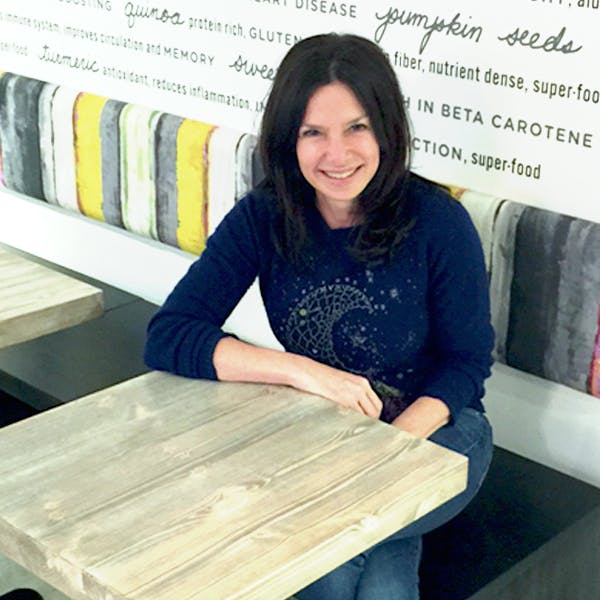 a woman sitting on a wooden table