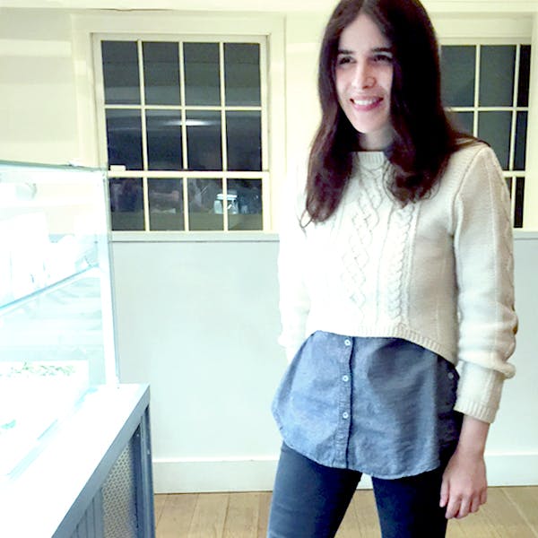 a woman standing in front of a window