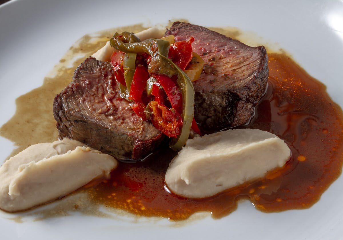 a piece of meat on a white plate