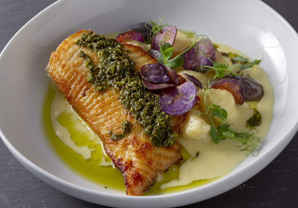 a white plate topped with meat and vegetables