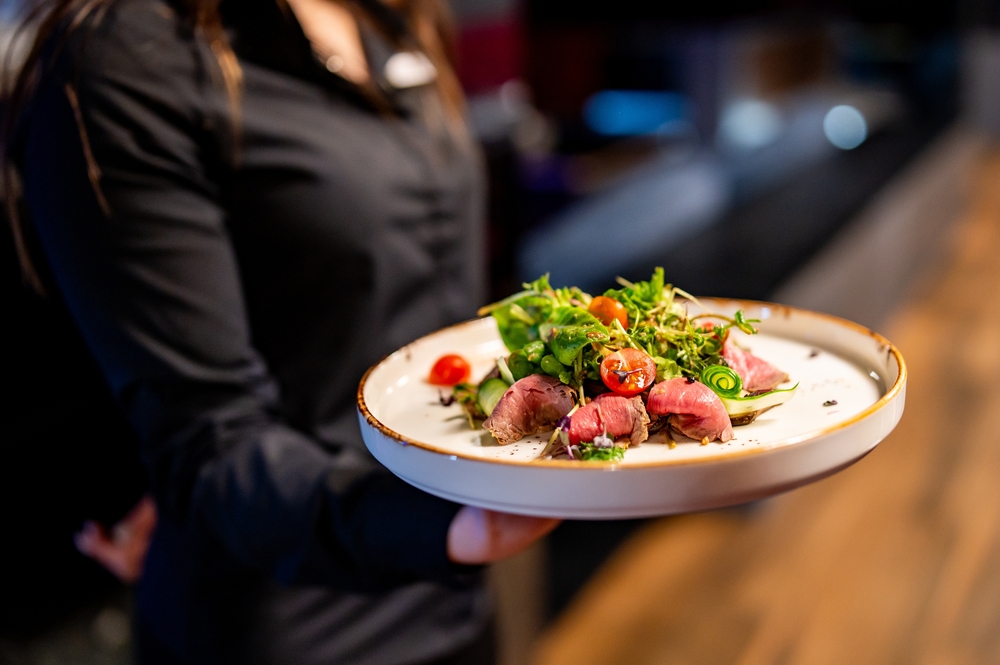 a person sitting at a table with a plate of food