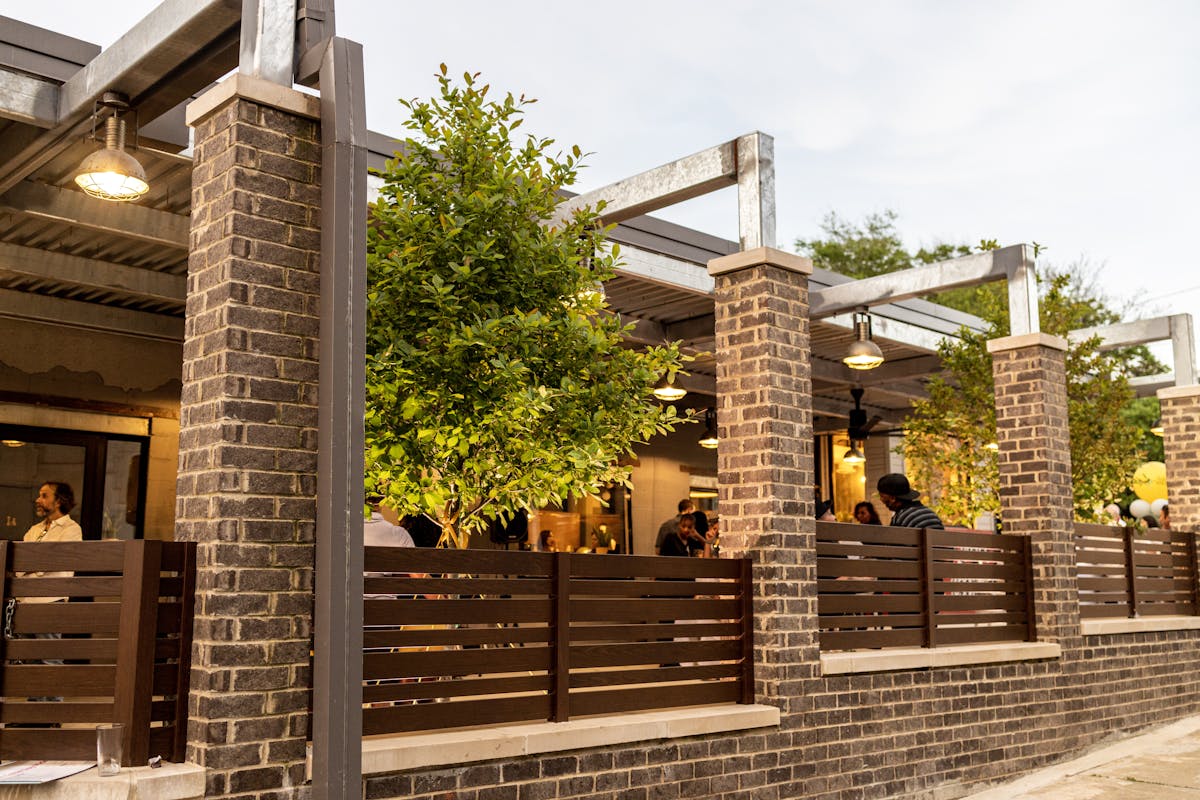 a bench in front of a brick building